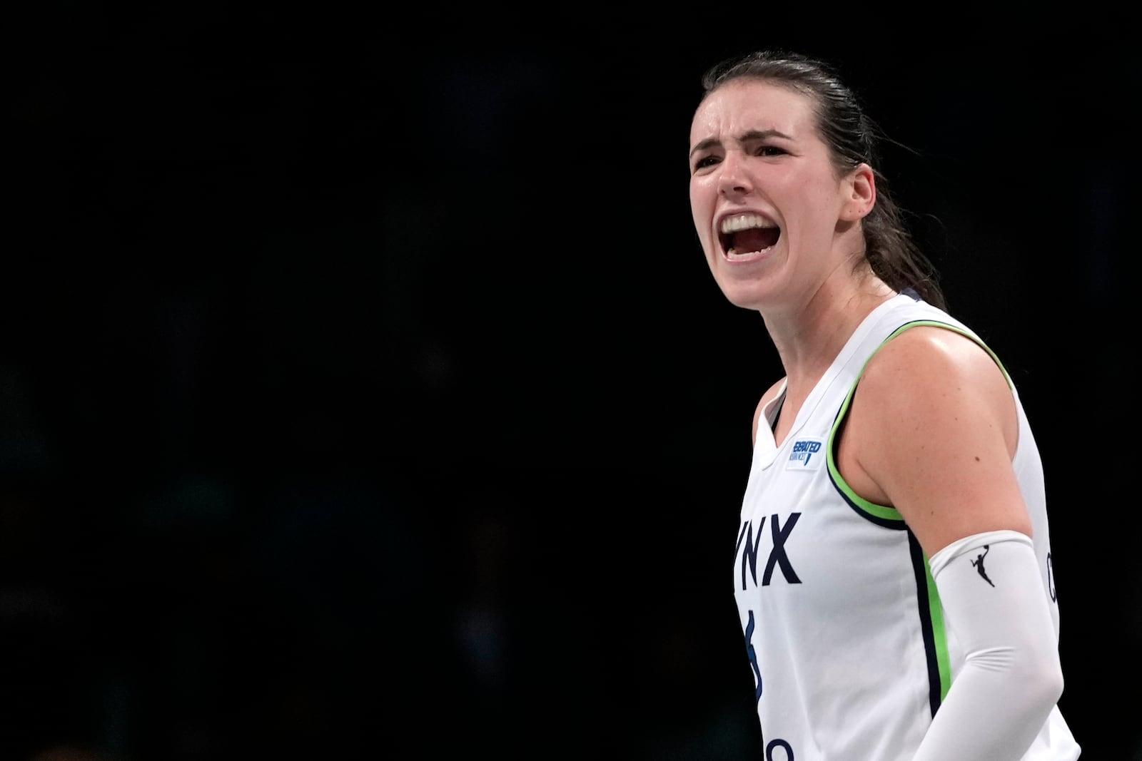 Minnesota Lynx's Bridget Carleton reacts after Courtney Williams scored during overtime in Game 1 of a WNBA basketball final playoff series against the New York Liberty, Thursday, Oct. 10, 2024, in New York. (AP Photo/Pamela Smith)