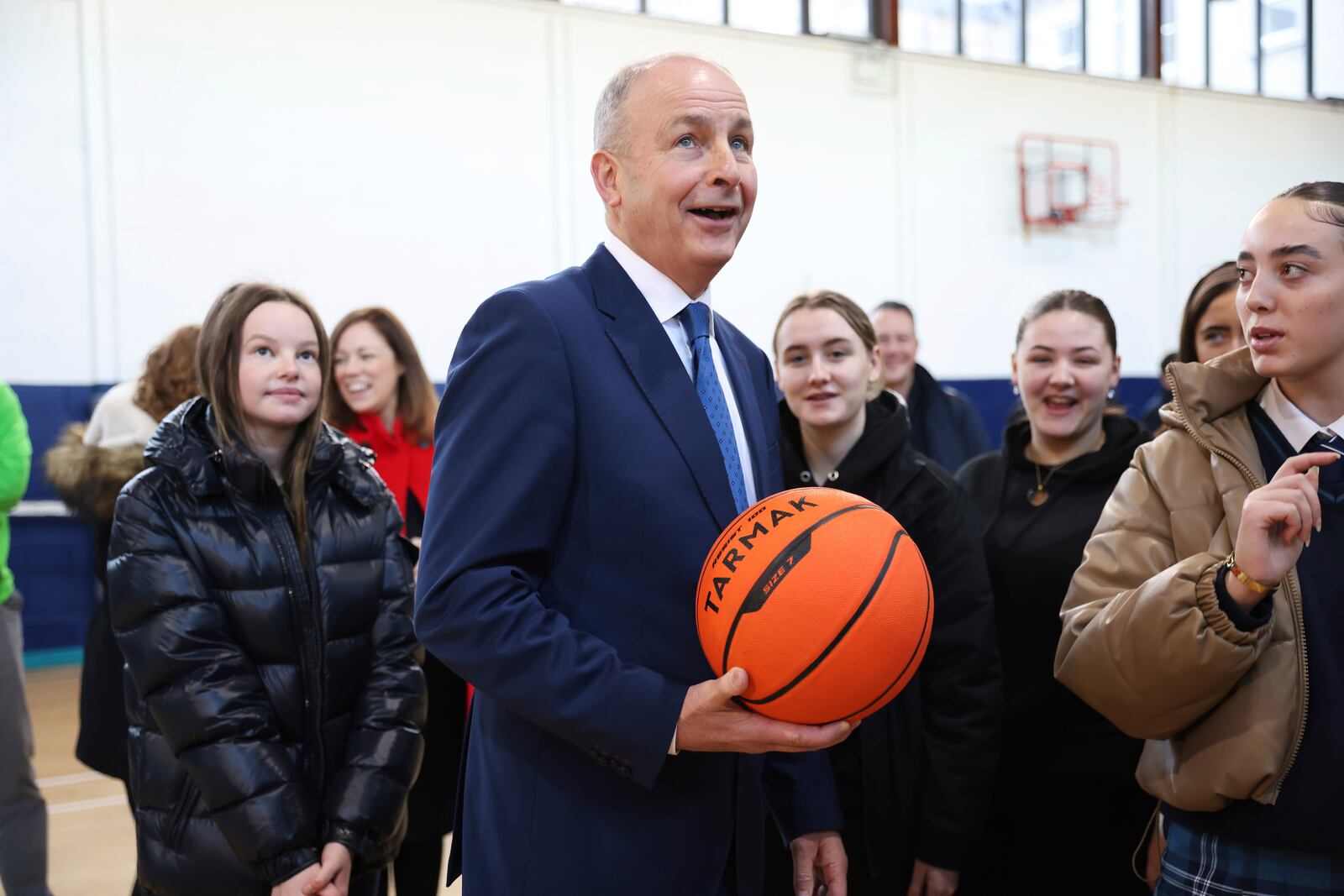 Micheal Martin, center, Tanaiste of Ireland and leader of Fianna Fail meets pupils at St Seton's Secondary School in Ballyfermot, Dublin, Ireland, Tuesday, Nov. 26, 2024. (AP Photo/Peter Morrison)