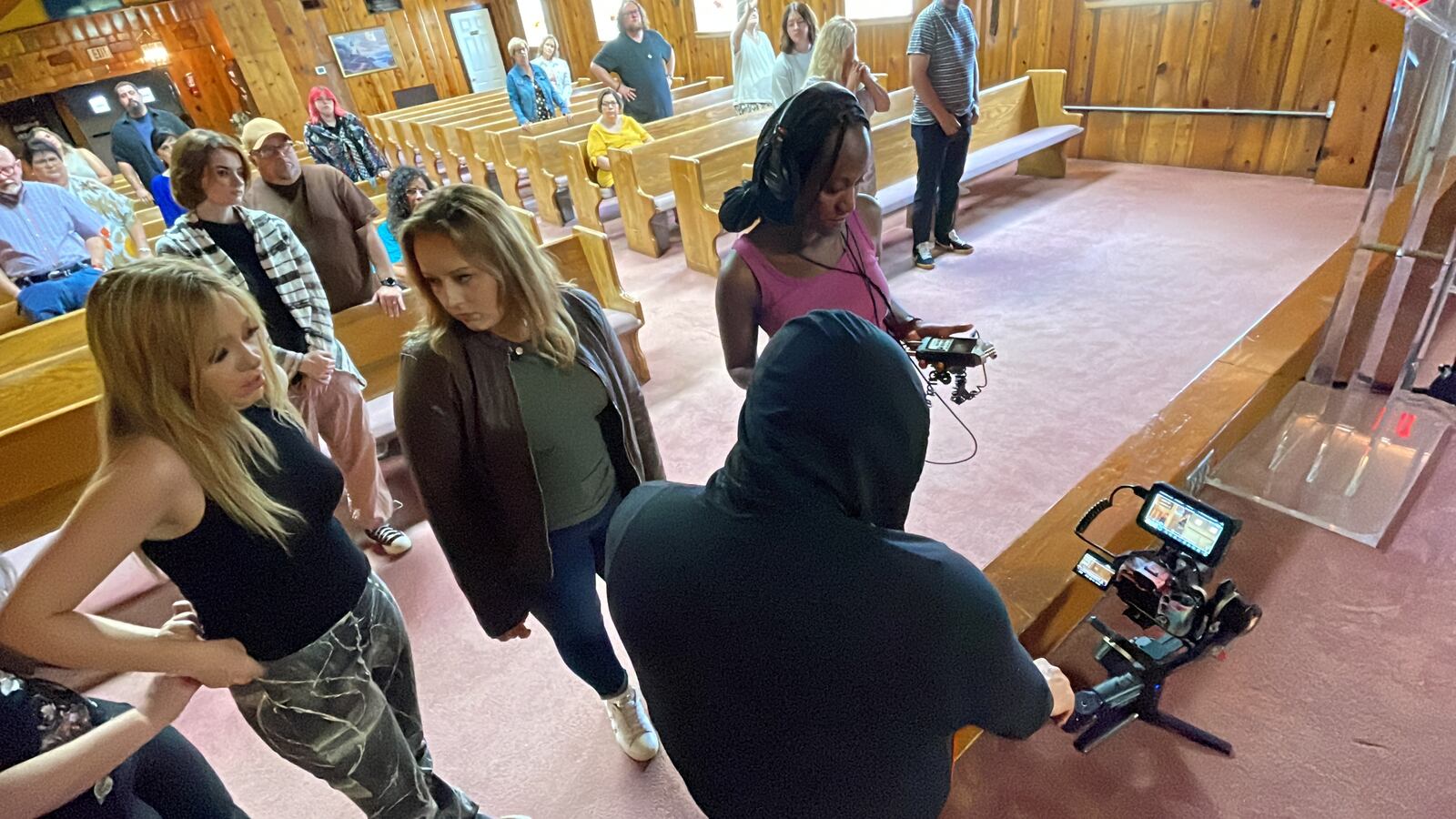 The independent movie "Just Peachy," written by actress and director Brittany Mcvicker, is being recorded at a church in New Miami. Pictured is a discussion after recording some scenes on Saturday, July 29, 2023, with Mcvicker talking with co-star Grace Balbo as videographer William Newton and production assistant Jassa Deen review b-roll shots. “Just Peachy” is expected to be released as a short film in the fall, and there are discussions about making it a feature-length independent movie. MICHAEL D. PITMAN/STAFF