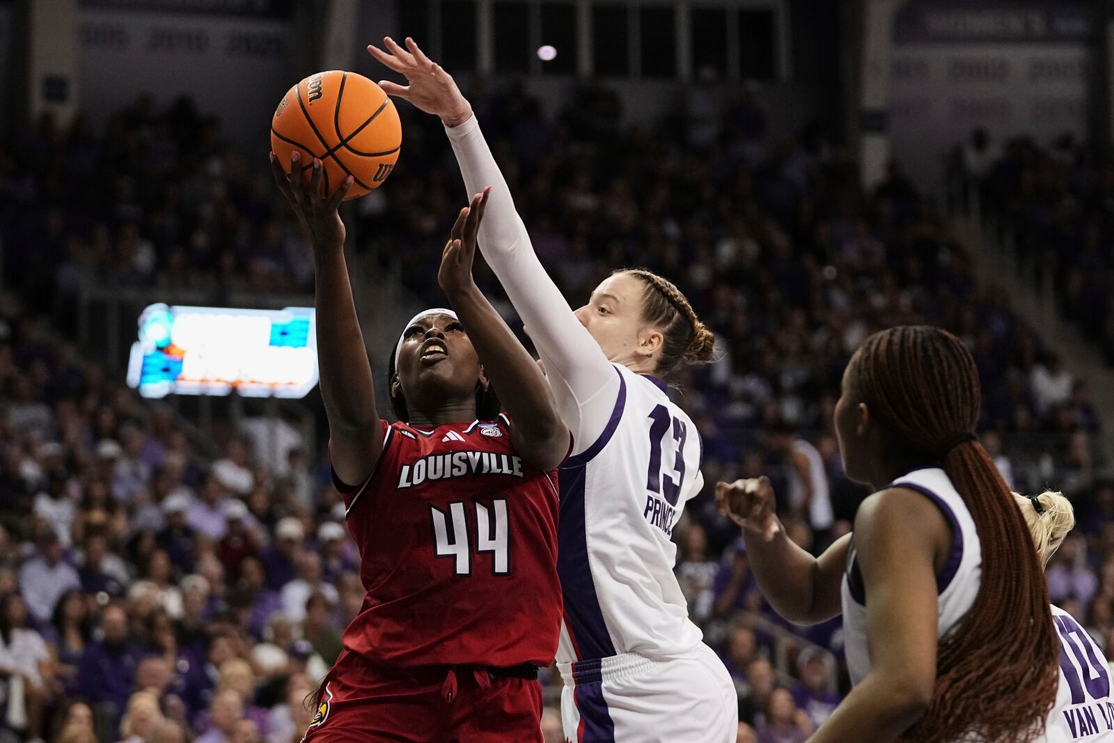 Louisville's Olivia Cochran (44) shoots as TCU's Sedona Prince (13) defends in the first half in the second round of the NCAA college basketball tournament in Fort Worth, Texas, Sunday, March 23, 2025. (AP Photo/Tony Gutierrez)