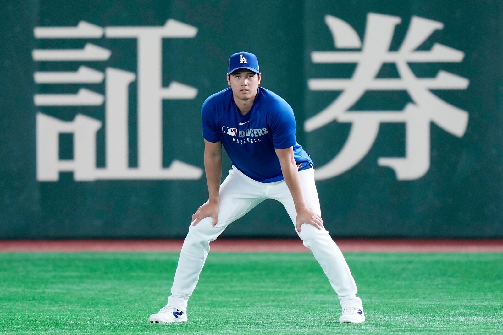 Los Angeles Dodgers two-way player Shohei Ohtani warms up during the official training, Friday, March 14, 2025, in Tokyo, ahead of the start of the MLB Tokyo Series at the Tokyo Dome. (AP Photo/Eugene Hoshiko)