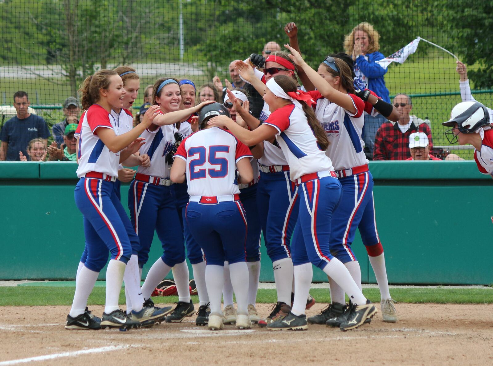 Springfield Northwestern’s Bry White is congratulated by her teammate after hitting a fifth-inning home run against Badin on Wednesday in a Division III regional semifinal at Wright State University. CONTRIBUTED PHOTO BY GREG BILLING