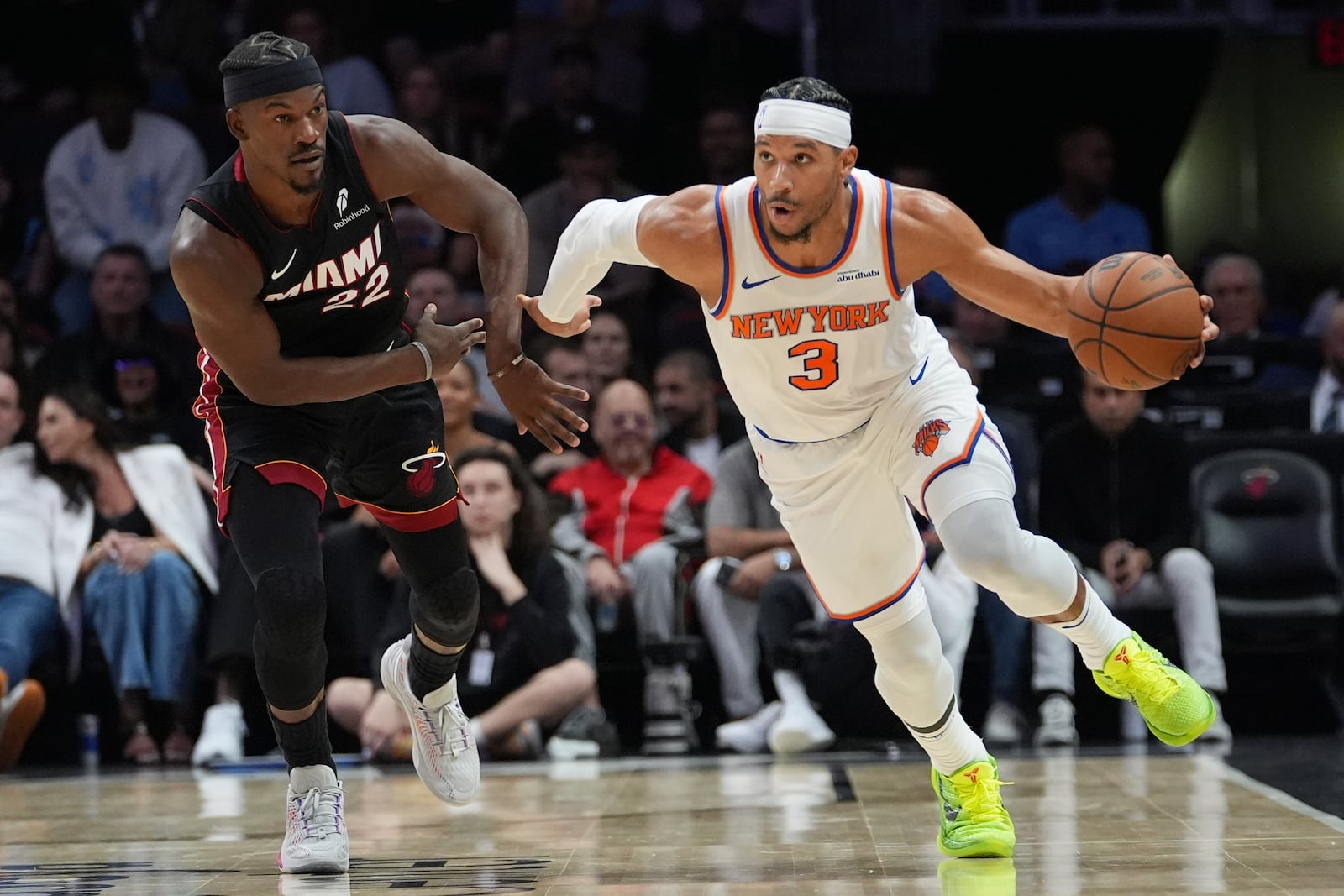 New York Knicks guard Josh Hart (3) moves the ball down the court as Miami Heat forward Jimmy Butler (22) defends during the first half of an NBA basketball game, Wednesday, Oct. 30, 2024, in Miami. (AP Photo/Lynne Sladky)