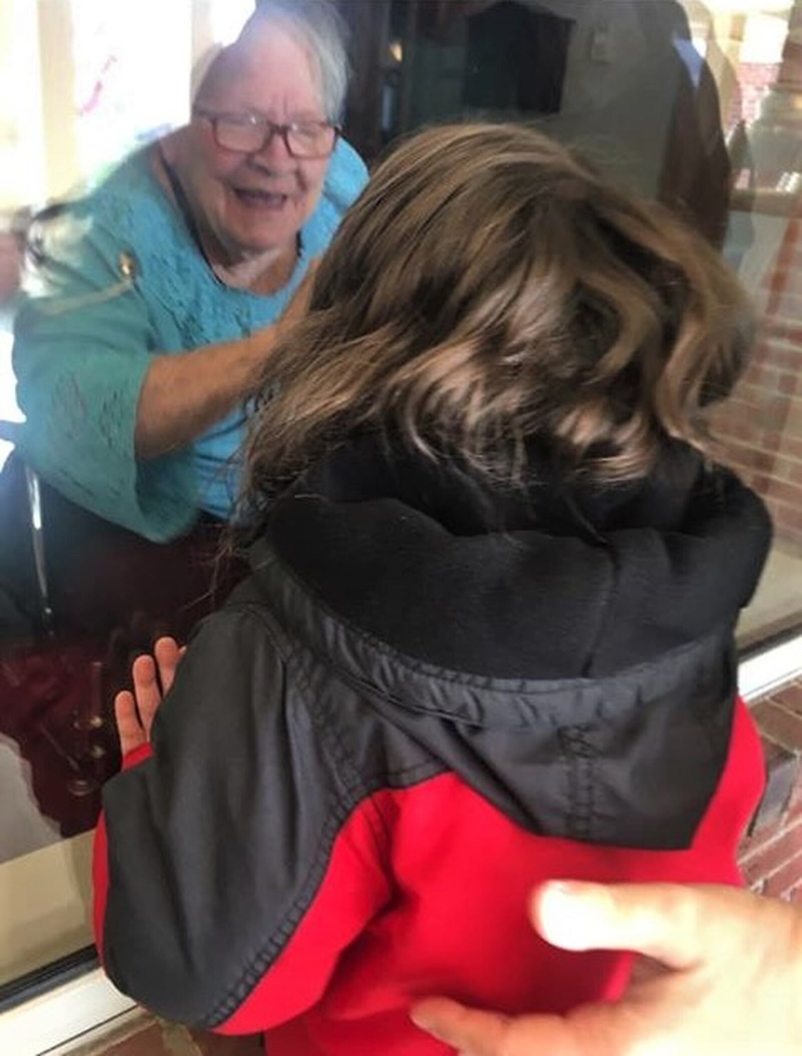 Graham Golden visits his grandma, Marge Golden, outside the window at Hearth & Home at Harding in Springfield due to restrictions because of the coronavirus threat.