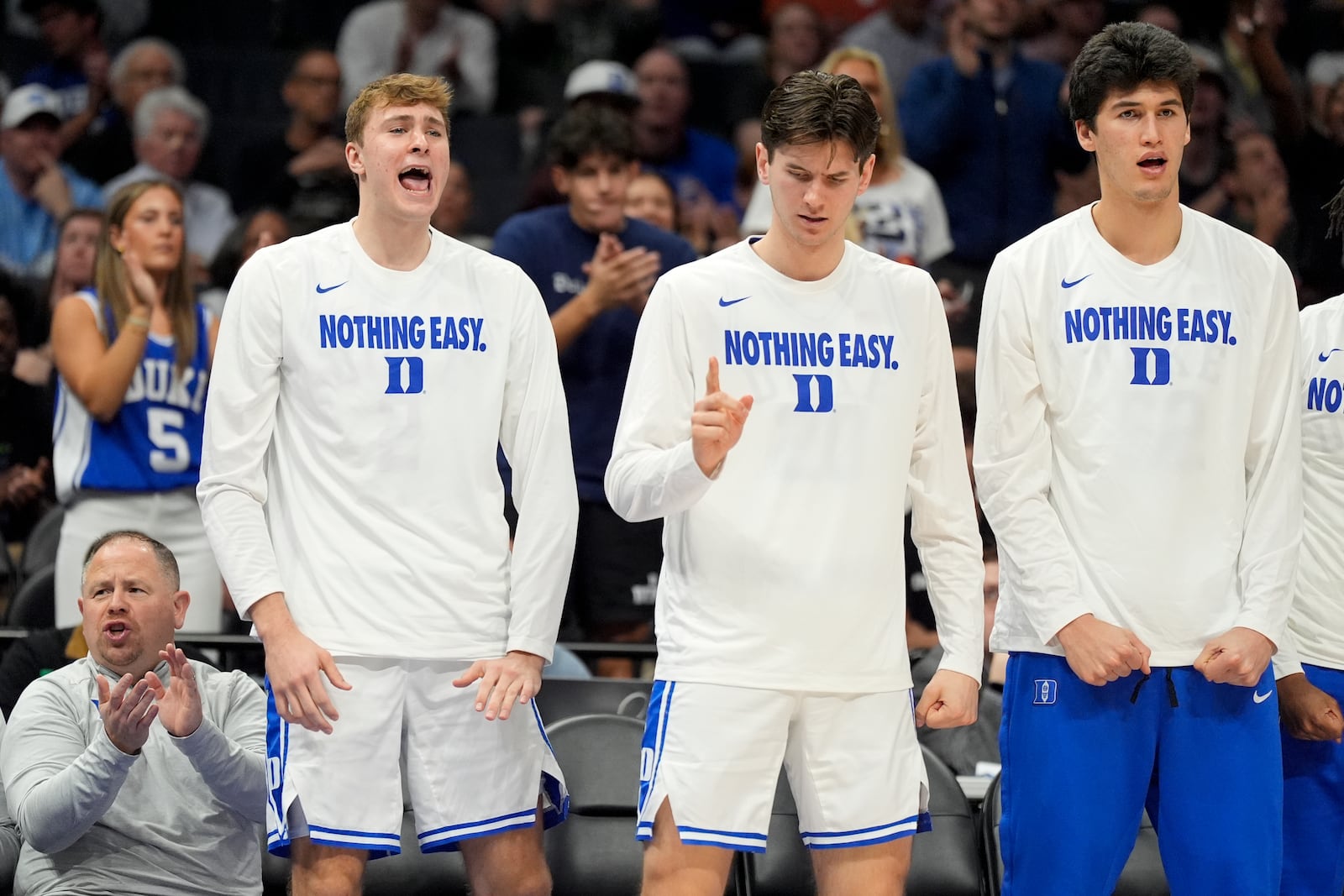 Duke forward Cooper Flagg, left, cheers from the bench during the second half of an NCAA college basketball game against Georgia Tech in the quarterfinals of the Atlantic Coast Conference tournament, Thursday, March 13, 2025, in Charlotte, N.C. Flagg was injured in the first half. (AP Photo/Chris Carlson)