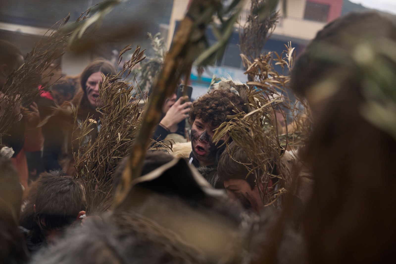 Revelers dressed in animal skins and heavy bronze bells, chant during carnival celebrations in Distomo, a village in central Greece, on Monday, March 3, 2025. (AP Photo/Petros Giannakouris)