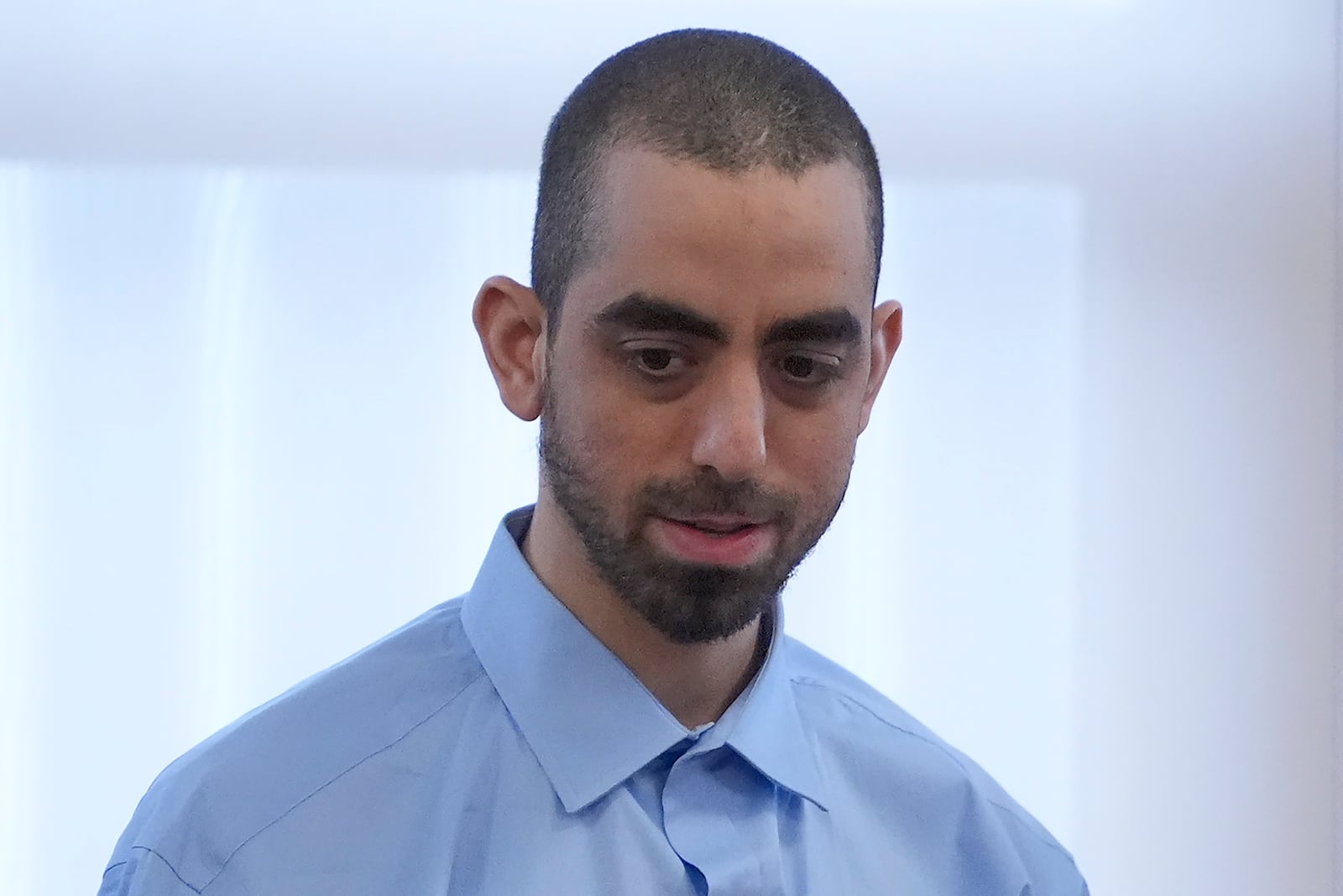 Hadi Matar talks with his defense team before leaving the courtroom at the Chautauqua County courthouse after his second day of trial, Tuesday, Feb. 11, 2025, in Mayville, N.Y. Matar is charged with stabbing famed author Salman Rushdie. (AP Photo/Gene J. Puskar)