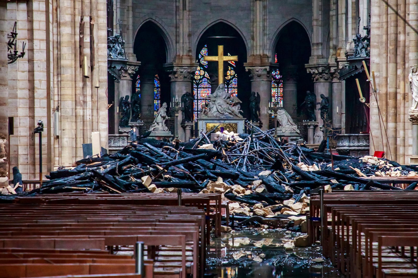 FILE - A hole is seen in the dome inside Notre Dame cathedral after the fire in Paris, Tuesday, April 16, 2019. (Christophe Petit Tesson, Pool via AP, File)