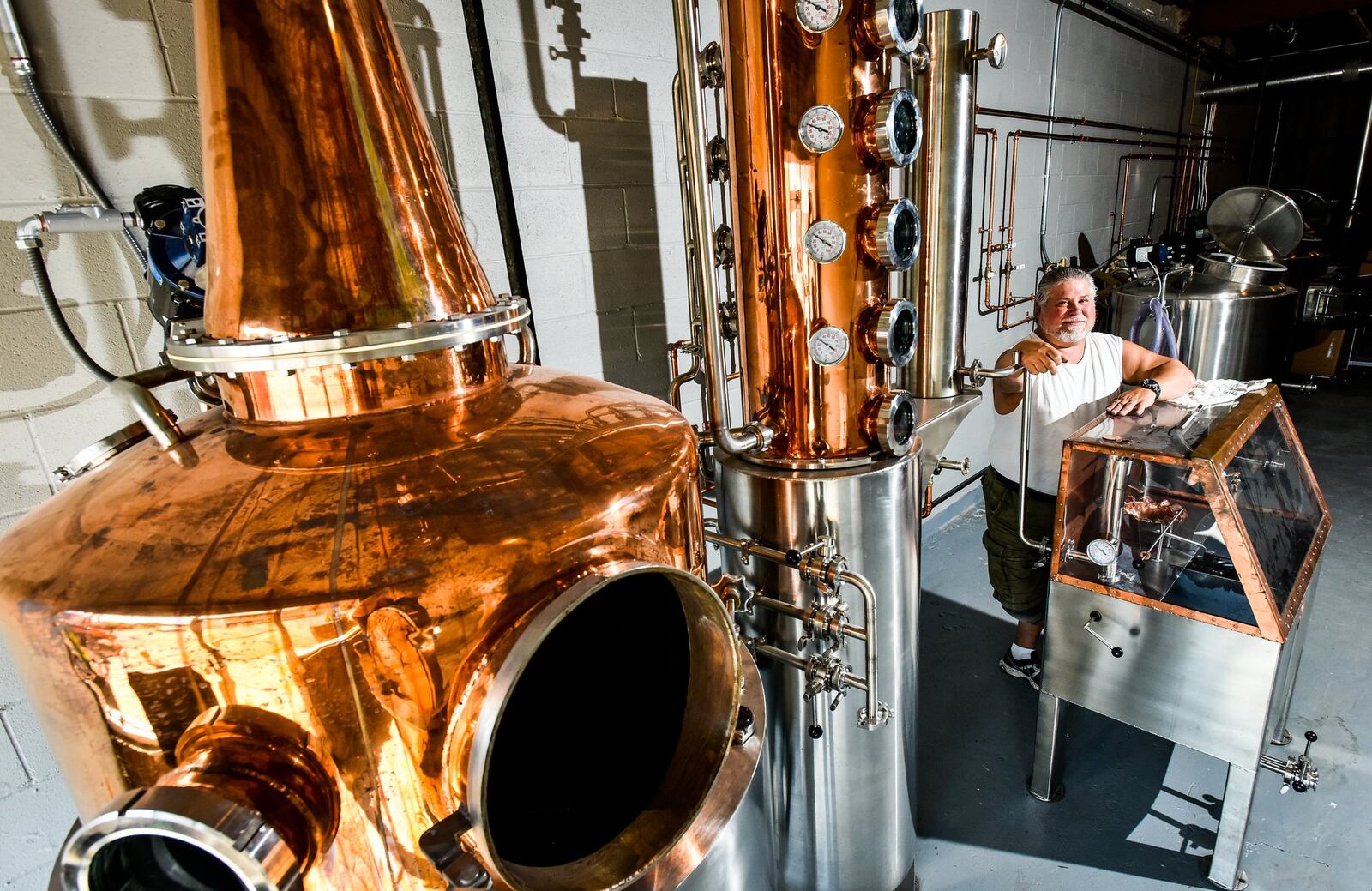 Mike Dranschak stands by the still inside White Dog Distilling Company  on Central Avenue in Middletown. 