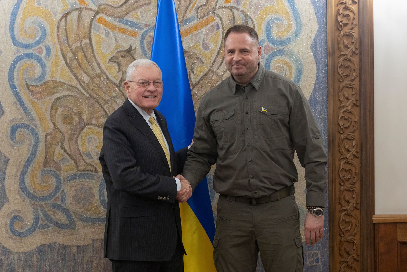 In this photo provided by the Press Service Of The President Of Ukraine on Wednesday Feb. 19, 2025, USA Envoy to Ukraine Keith Kellogg and Head of Ukrainian Presidential Office Andriy Yermak shake hands during a meeting in Kyiv, Ukraine. (Press Service Of The President Of Ukraine via AP)