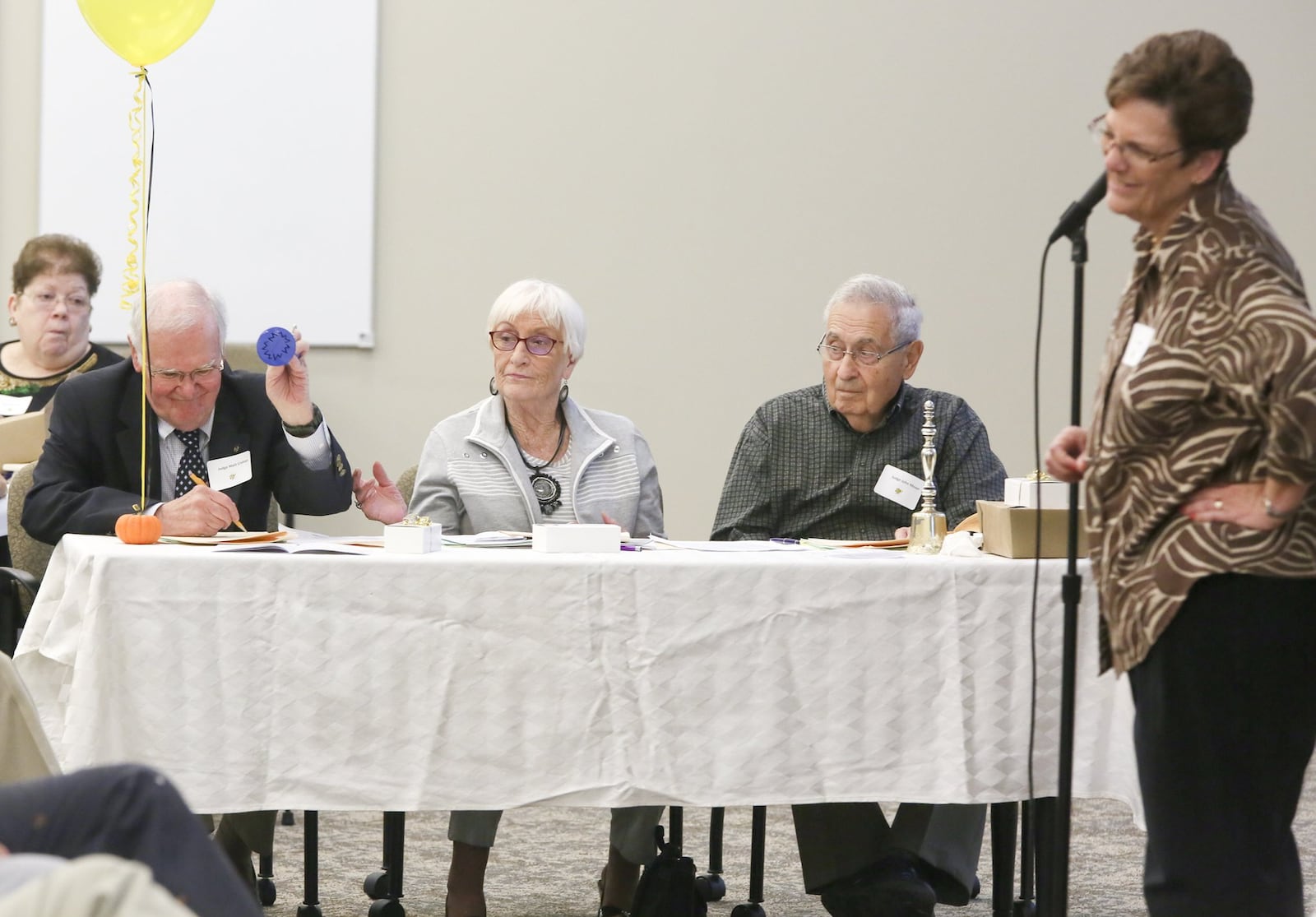 Judge Matthew Crehan (left) signals a misspelling by Pat Adams as the other judges, Joyce Thall and John Moser, look on during the Altrusa Club of Hamilton’s sixth annual spelling bee on Friday, Oct. 2. GREG LYNCH / STAFF