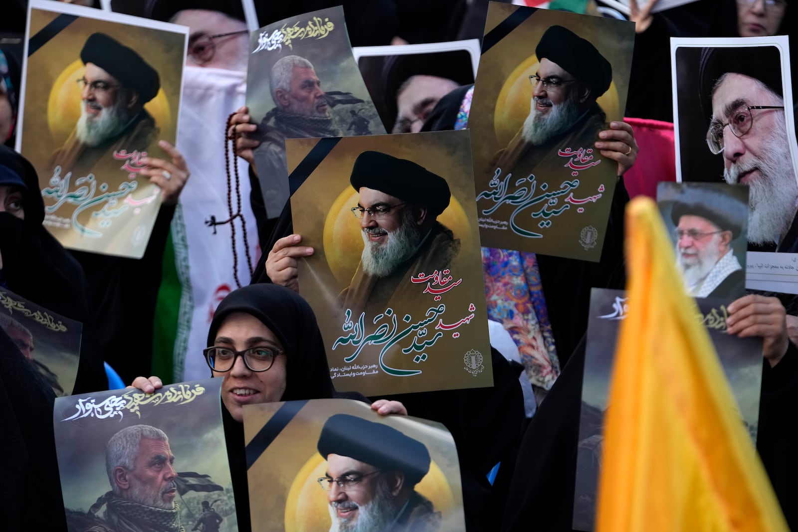 Iranian demonstrators hold posters of slain Hezbollah leader Hassan Nasrallah, center, late leader of Hamas, Yahya Sinwar, who was killed in a battle with Israel, bottom left, and Iranian Supreme Leader Ayatollah Ali Khamenei, top right, in a ceremony commemorating Sinwar and Hashem Safieddine, a powerful cleric who was expected to succeed Hassan Nasrallah and was killed by an Israeli airstrike in Beirut, at the Felestin (Palestine) Sq. in Tehran, Iran, Thursday, Oct. 24, 2024. (AP Photo/Vahid Salemi)