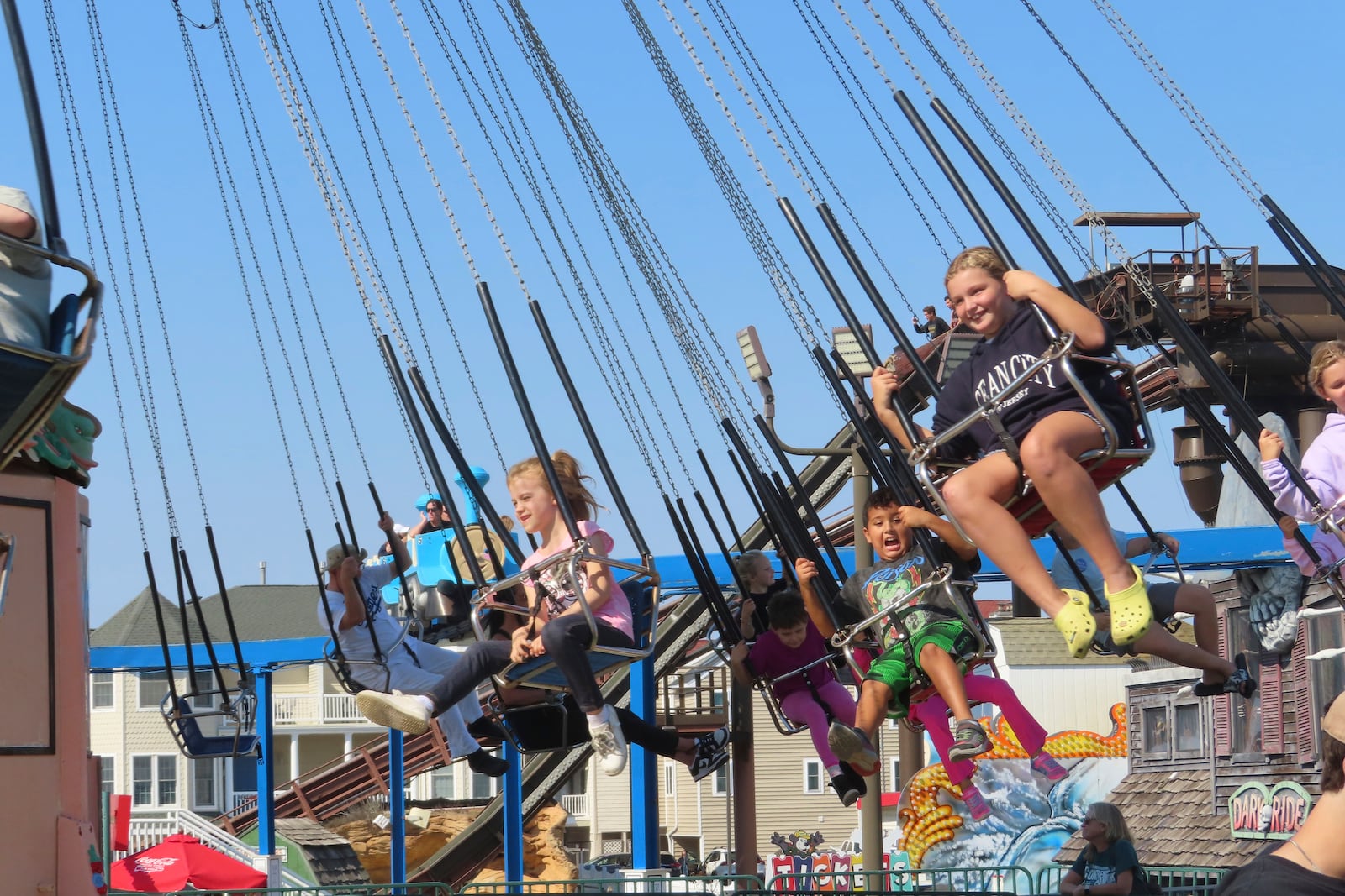 People ride the swing chair attraction at Gillian's Wonderland, the popular amusement park on the boardwalk in Ocean City, N.J., during its final day of operation before shutting down for good, Sunday. Oct. 13, 2024. (AP Photo/Wayne Parry)