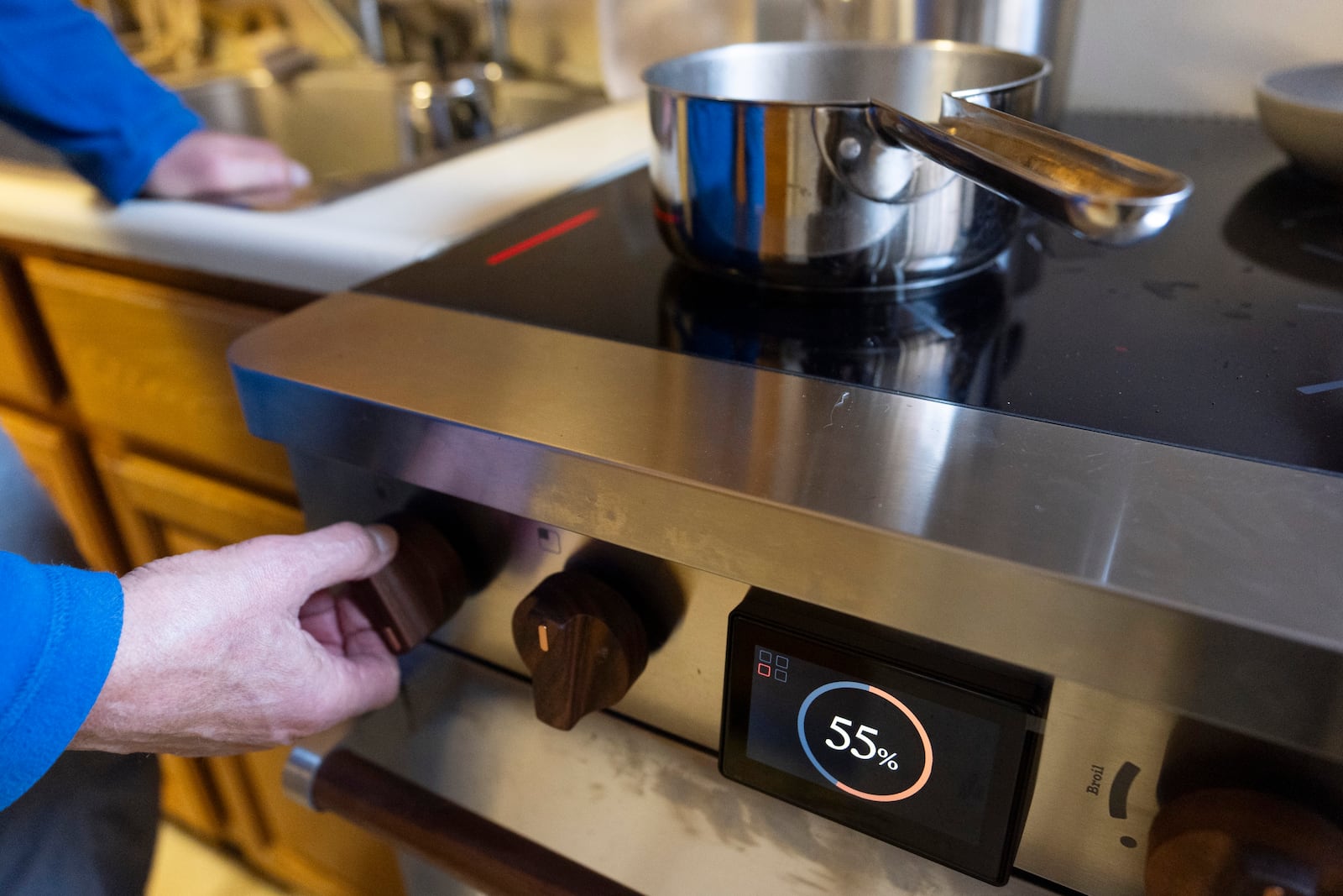 Ed Yaker boils water on a Copper stove, an electric induction stove, on Feb. 10, 2025, in New York. (AP Photo/John Minchillo)