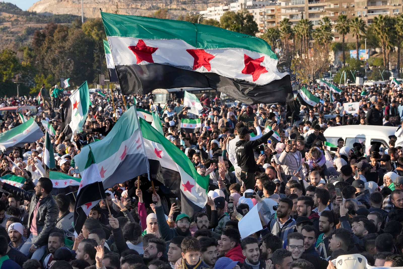 FILE - Syrians celebrate at the first Friday prayers since Bashar Assad's ouster at the central square in Damascus, Syria, on Dec. 13, 2024. (AP Photo/Hussein Malla, File)