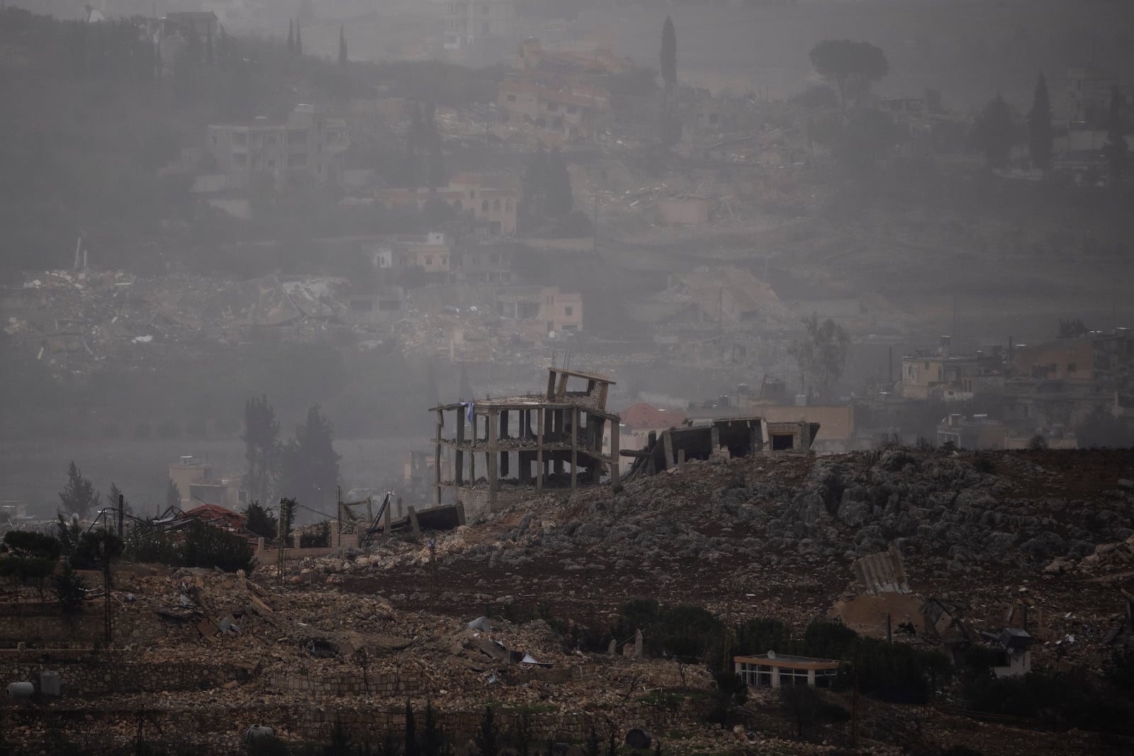 Destroyed buildings stand on an area of a village in southern Lebanon as seen from northern Israel, Monday, Nov. 25, 2024. (AP Photo/Leo Correa)