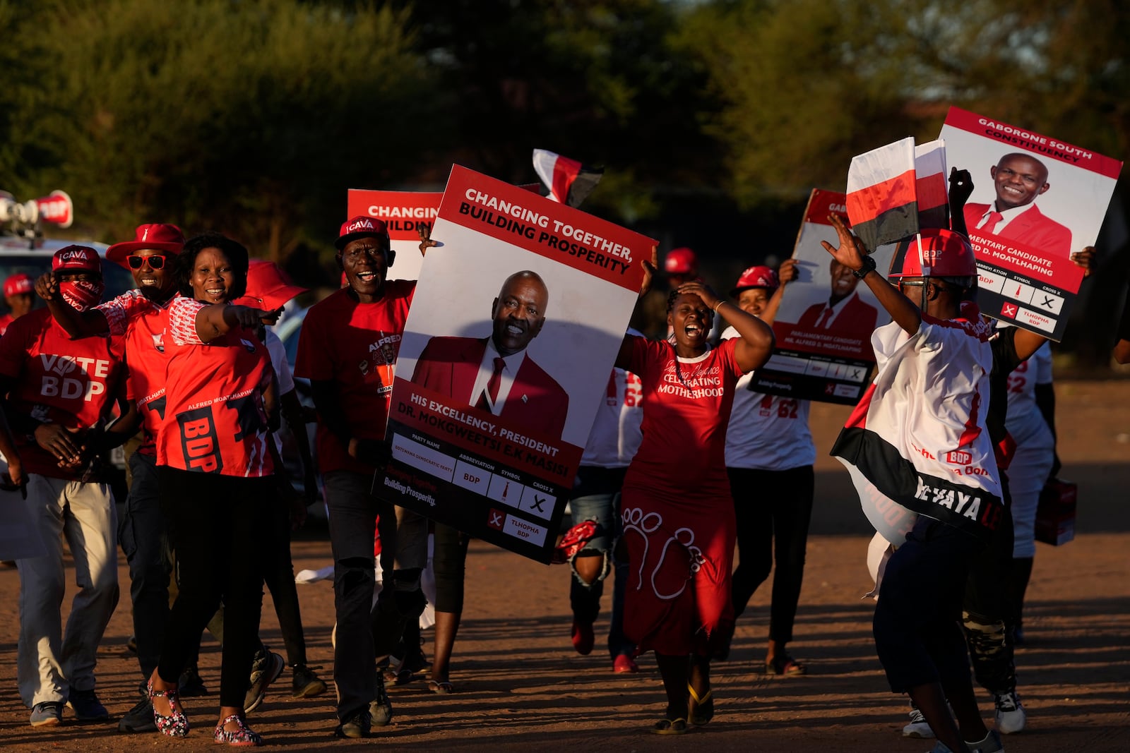 Members of the Botswana Democratic Party sing and dance as they arrive for their election rally, a day before elections in Gaborone, Botswana, Tuesday, Oct. 29, 2024. (AP Photo/Themba Hadebe)