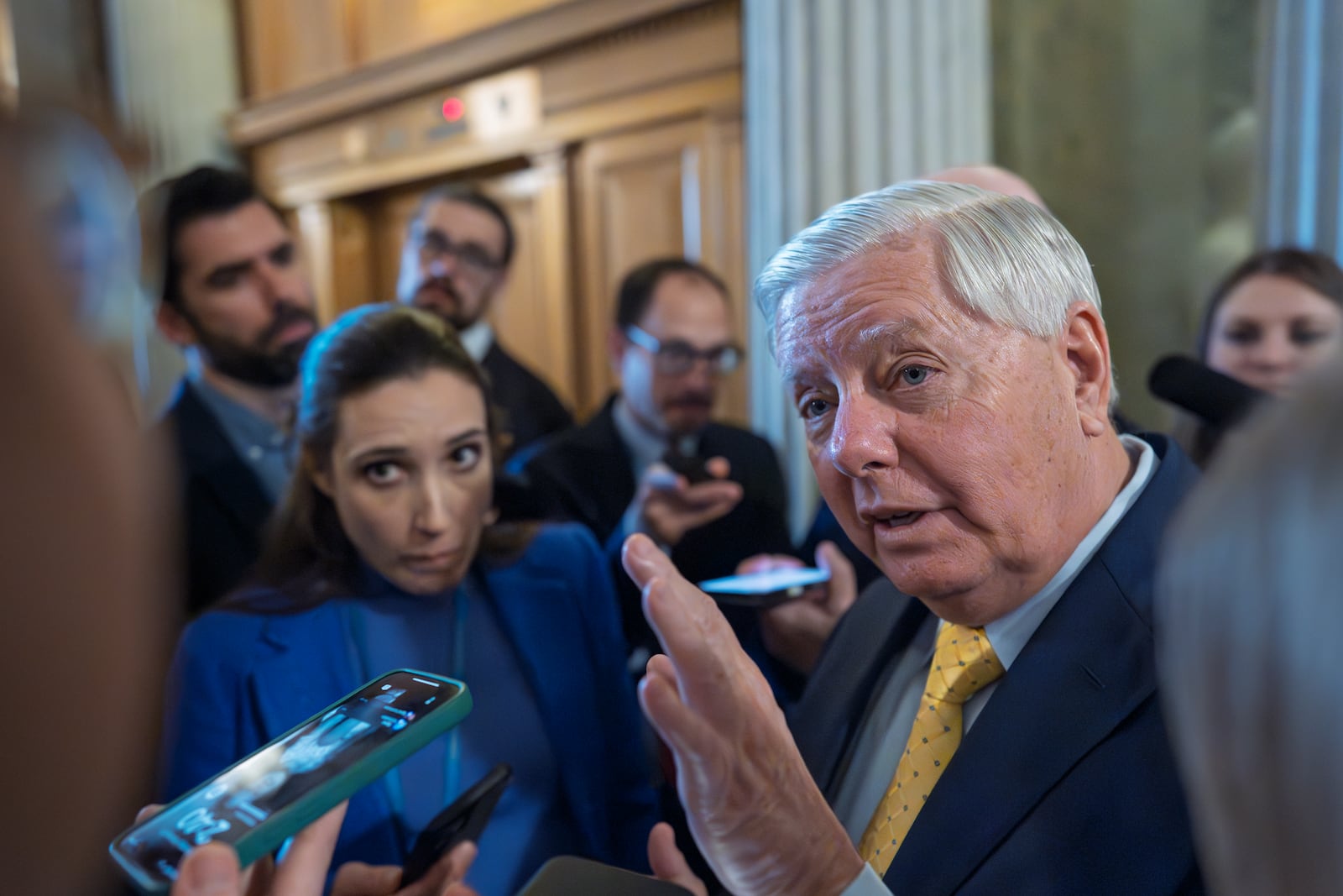 Sen. Lindsey Graham, R-S.C., chairman of the Senate Budget Committee, is surrounded by reporters asking about his plans to move ahead with a spending bill, at the Capitol in Washington, Tuesday, Feb. 11, 2025. (AP Photo/J. Scott Applewhite)