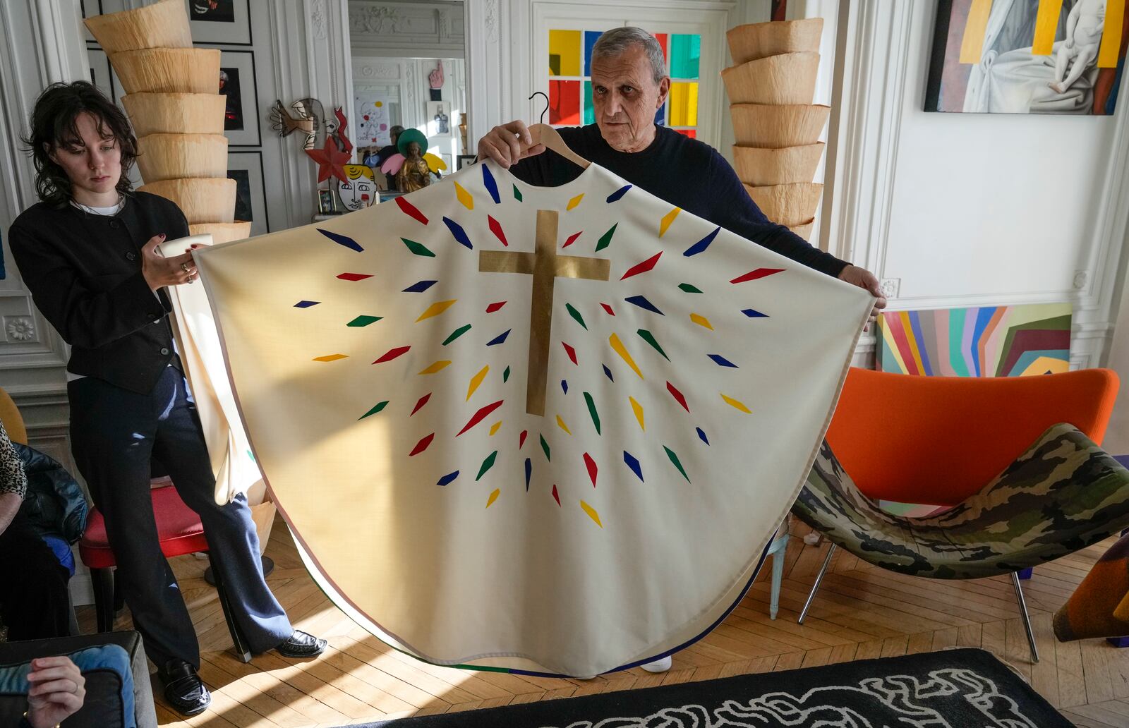 Designer Jean-Charles de Castelbajac displays a liturgical vestment for priests and to be worn at the reopening of Paris' Notre-Dame Cathedral in December, Wednesday, Nov. 20, 2024 in Paris. (AP Photo/Michel Euler)