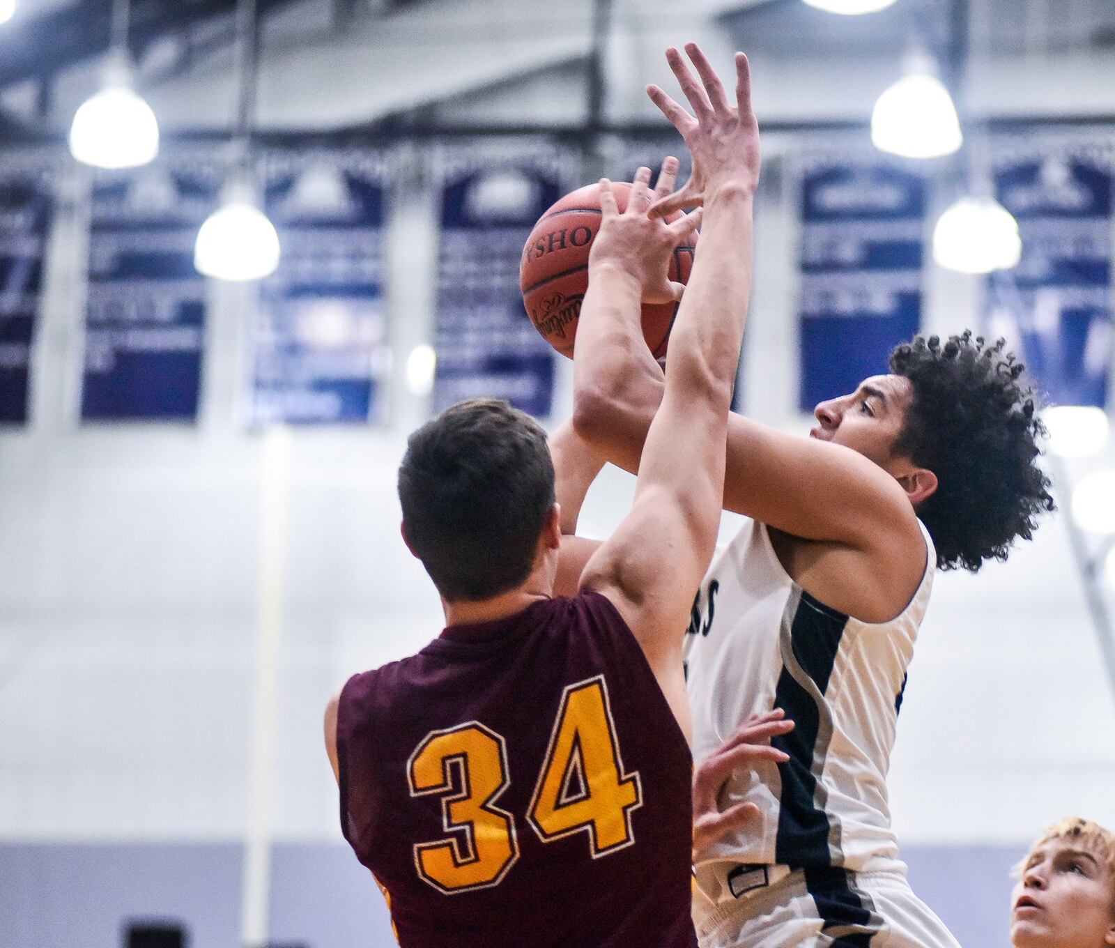 Max Stepaniak of Ross goes after a shot by Edgewood’s Isaiah Gambrell on Friday night in St. Clair Township. Visiting Ross won 49-34. NICK GRAHAM/STAFF