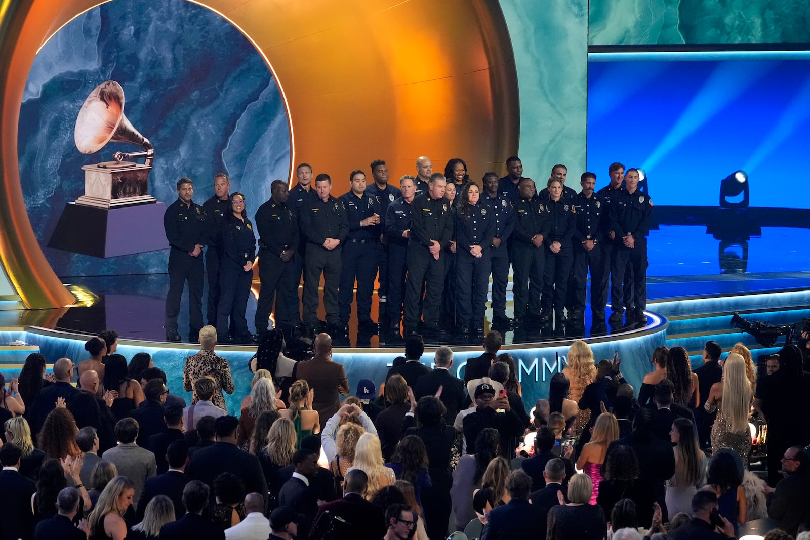 Members of the County of Los Angeles Fire Department present the award for album of the year during the 67th annual Grammy Awards on Sunday, Feb. 2, 2025, in Los Angeles. (AP Photo/Chris Pizzello)