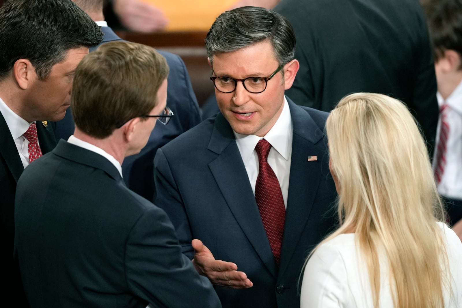 House Speaker Mike Johnson, R-La., speaks with Rep. Dusty Johnson, R-S.D., left, and Rep. Marjorie Taylor Greene, R-Ga., right, as the House of Representatives convenes the 119th Congress with a slim Republican majority, at the Capitol in Washington, Friday, Jan. 3, 2025. (AP Photo/J. Scott Applewhite)