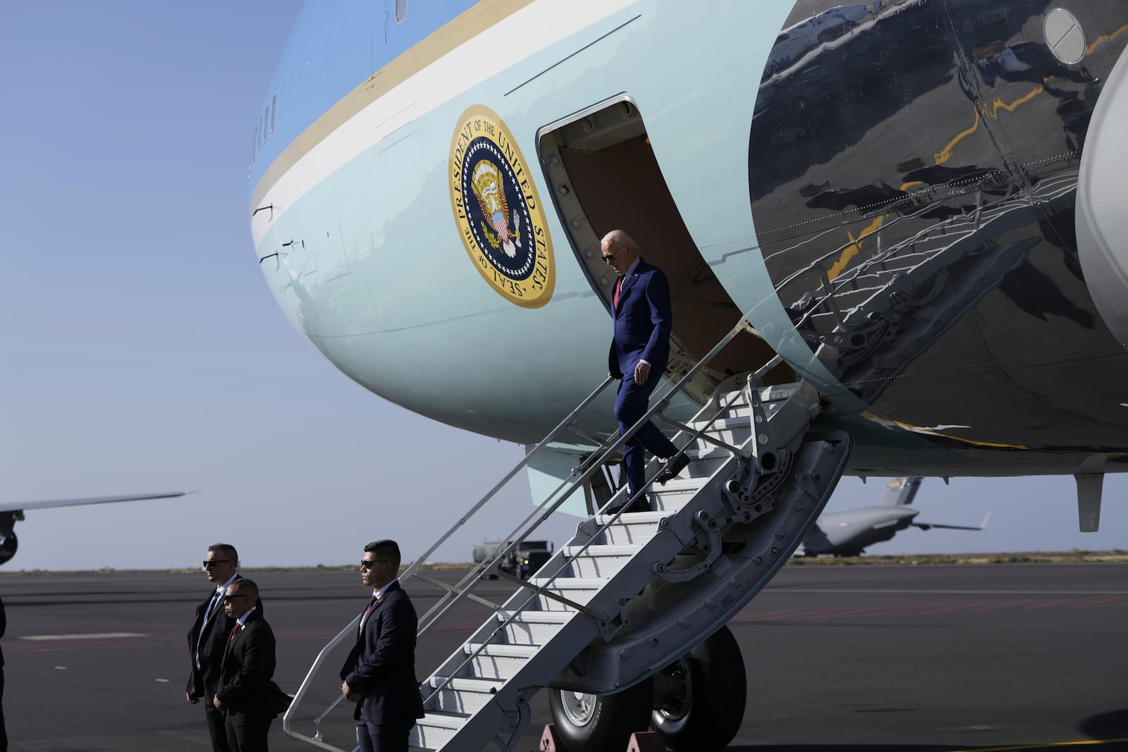 President Joe Biden walks from Air Force One at Amilcar Cabral international airport on Sal island, Cape Verde Monday, Dec. 2, 2024, en route to Angola as he makes his long-promised visit to Africa. (AP Photo/Ben Curtis)