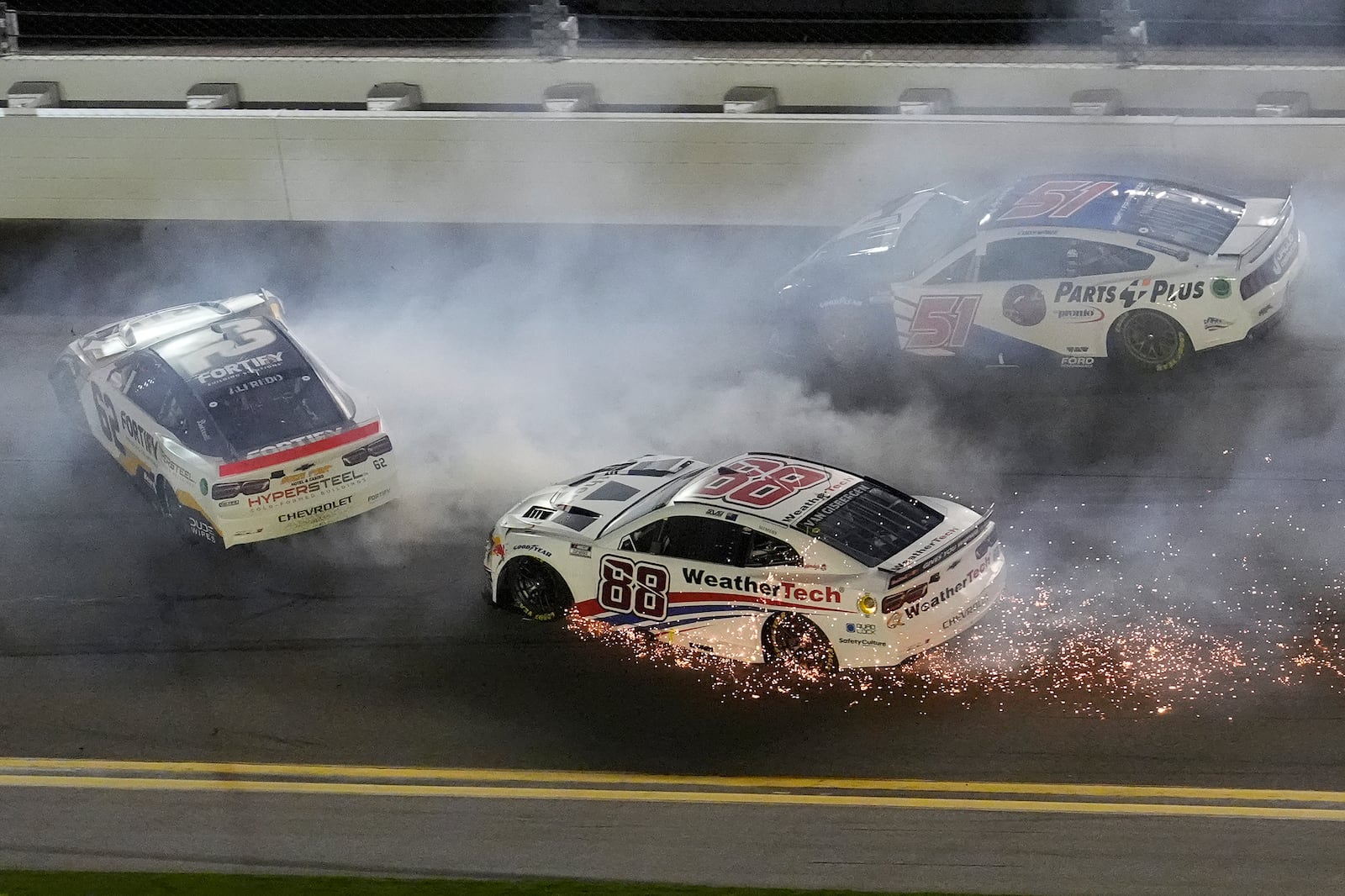 Anthony Alfredo (62), Shane Van Gisbergen (88), and Cody Ware (51) crash during the second of two NASCAR Daytona 500 qualifying auto races Thursday, Feb. 13, 2025, at Daytona International Speedway in Daytona Beach, Fla. (AP Photo/Chris O'Meara)