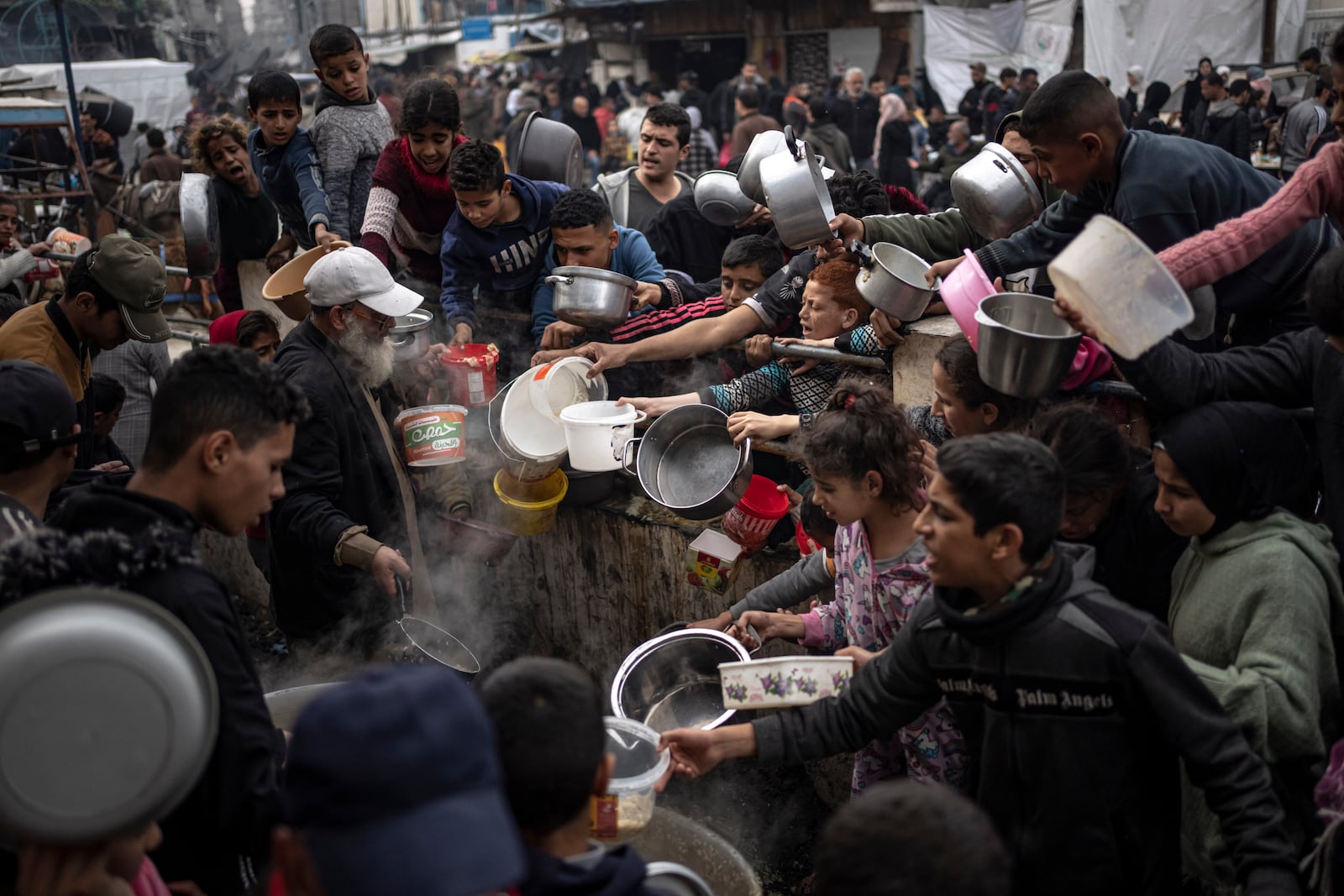 FILE - Palestinians line up for a meal in Rafah, Gaza Strip, on Dec. 21, 2023. (AP Photo/Fatima Shbair, File)