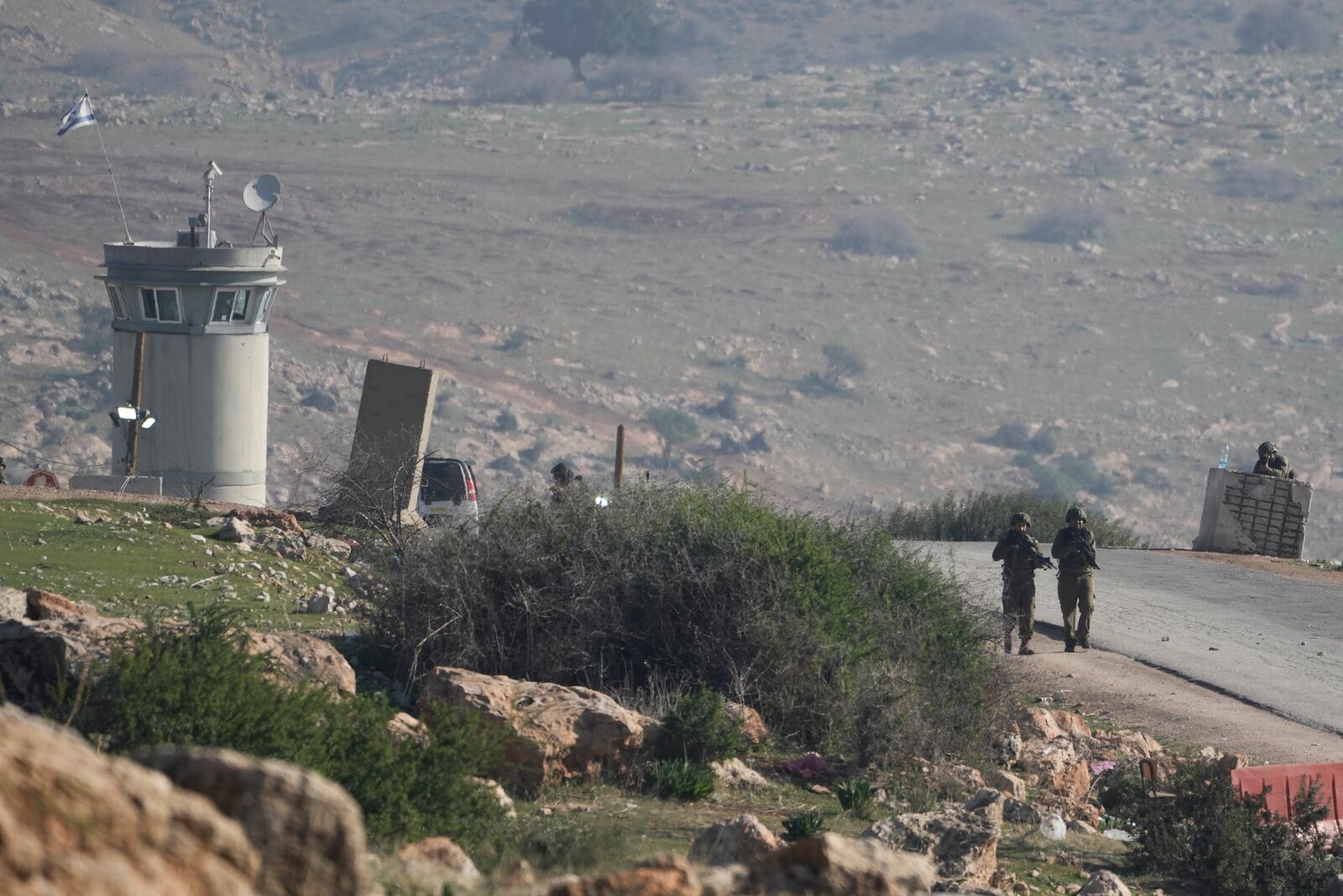 Israeli soldiers stand guard at a checkpoint where the military said an attacker fired at an army base near the village of Tayasir in the northern West Bank, Tuesday, Feb. 4, 2025. At least six soldiers were injured, and the attacker was killed by Israeli fire. (AP Photo/Majdi Mohammed)