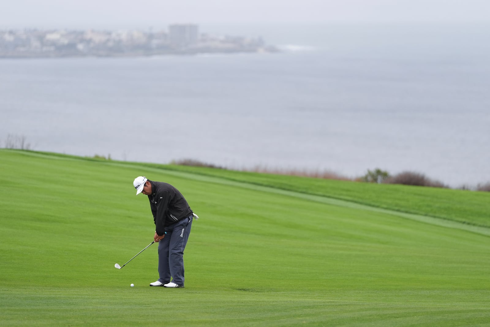 Hideki Matsuyama, of Japan, hits a shot on the fourth hole of the South Course at Torrey Pines during the first round of the Genesis Invitational golf tournament Thursday, Feb. 13, 2025, in San Diego. (AP Photo/Gregory Bull)