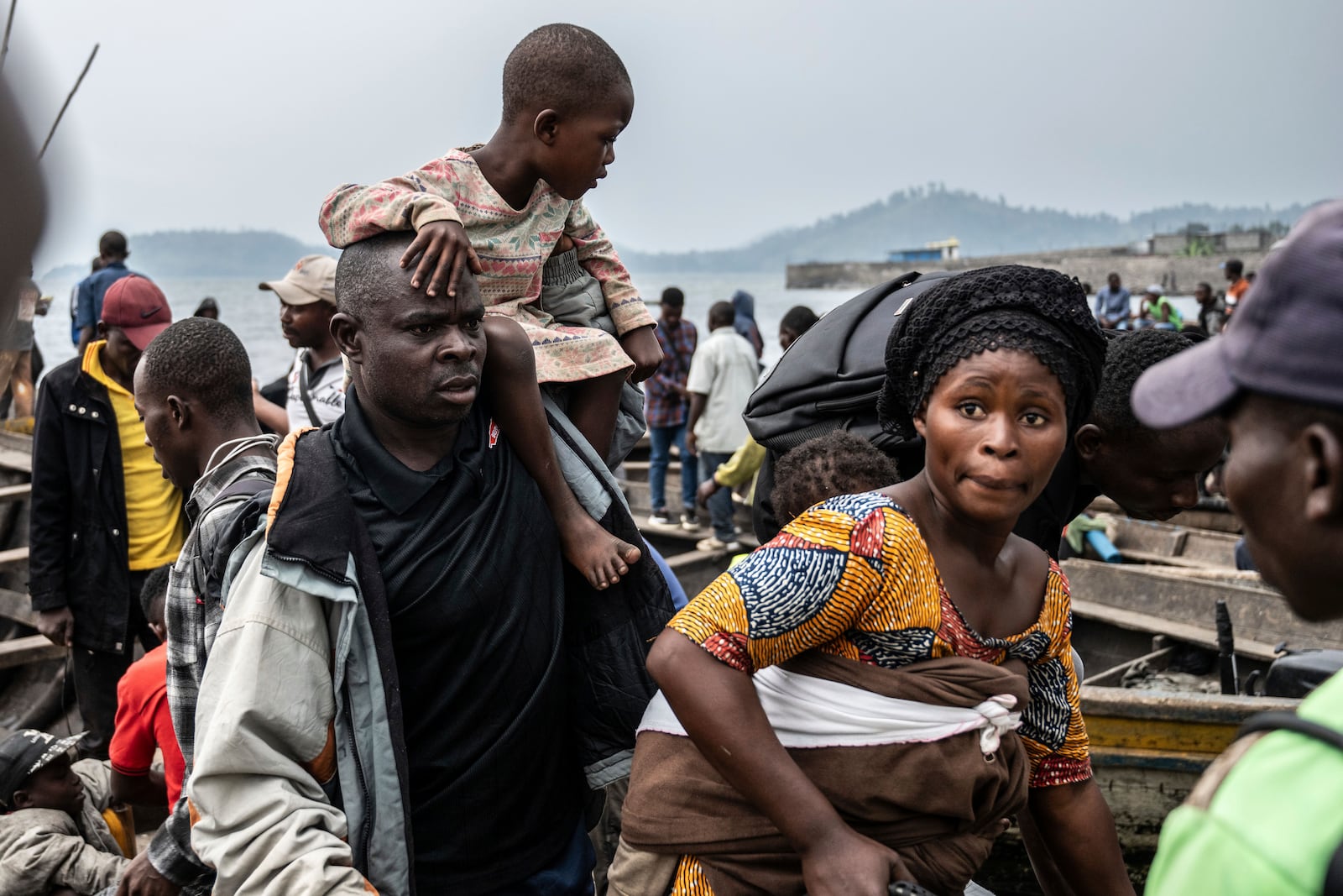 People fleeing M-23 rebel advances arrive by boat in Goma, Democratic Republic of the Congo, Wednesday, Jan. 22, 2025. (AP Photo/Moses Sawasawa)