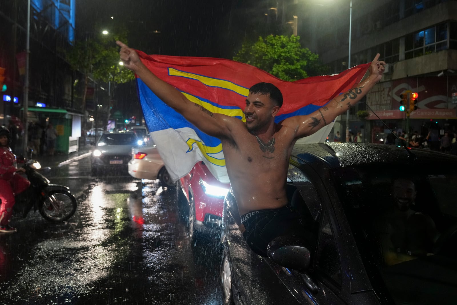 Supporters of the Broad Front (Frente Amplio) celebrate the victory of candidate Yamandú Orsi in the presidential run-off election in Montevideo, Uruguay, Sunday, Nov. 24, 2024. (AP Photo/Matilde Campodonico)