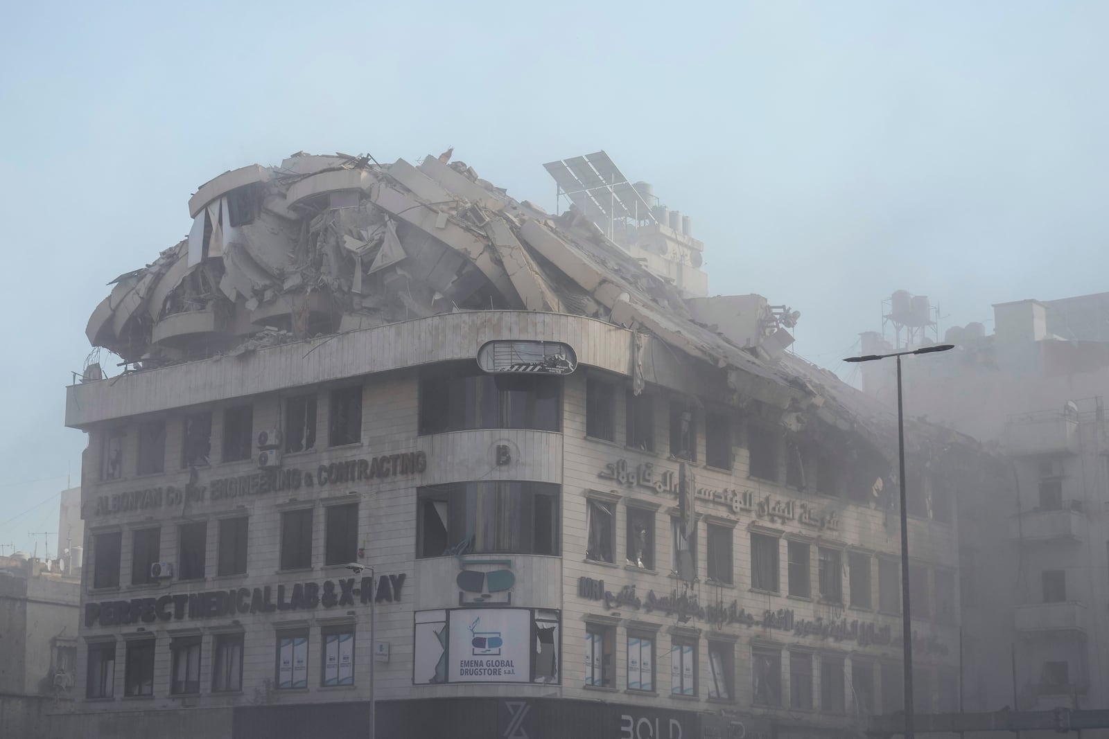 Smoke rises from a building that collapses following an Israeli airstrike on Chiyah, in the southern suburb of Beirut, Lebanon, Friday, Nov. 22, 2024. (AP Photo/Bilal Hussein)