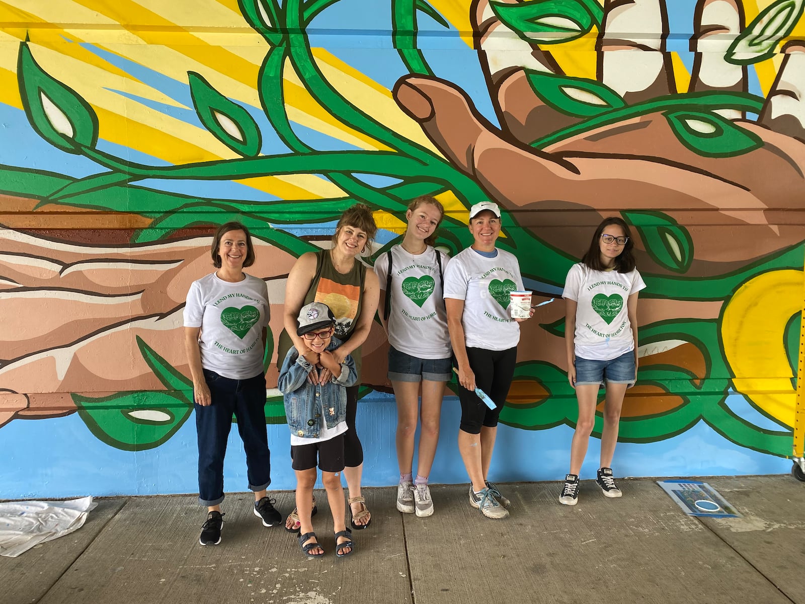 Envision Partnership's Health Hamilton Coalition commissioned a mural to be painted on the Main Street side under the High-Main Bridge in Hamilton. "Heart of Hamilton" was designed by Greater Cincinnati artist Dave Rickerd and painted by more than 30 Hamilton volunteers. They'll have a dedication and planned events on Saturday, June 29, 2024, to celebrate the latest mural in the city. PROVIDED/ENVISION PARTNERSHIP