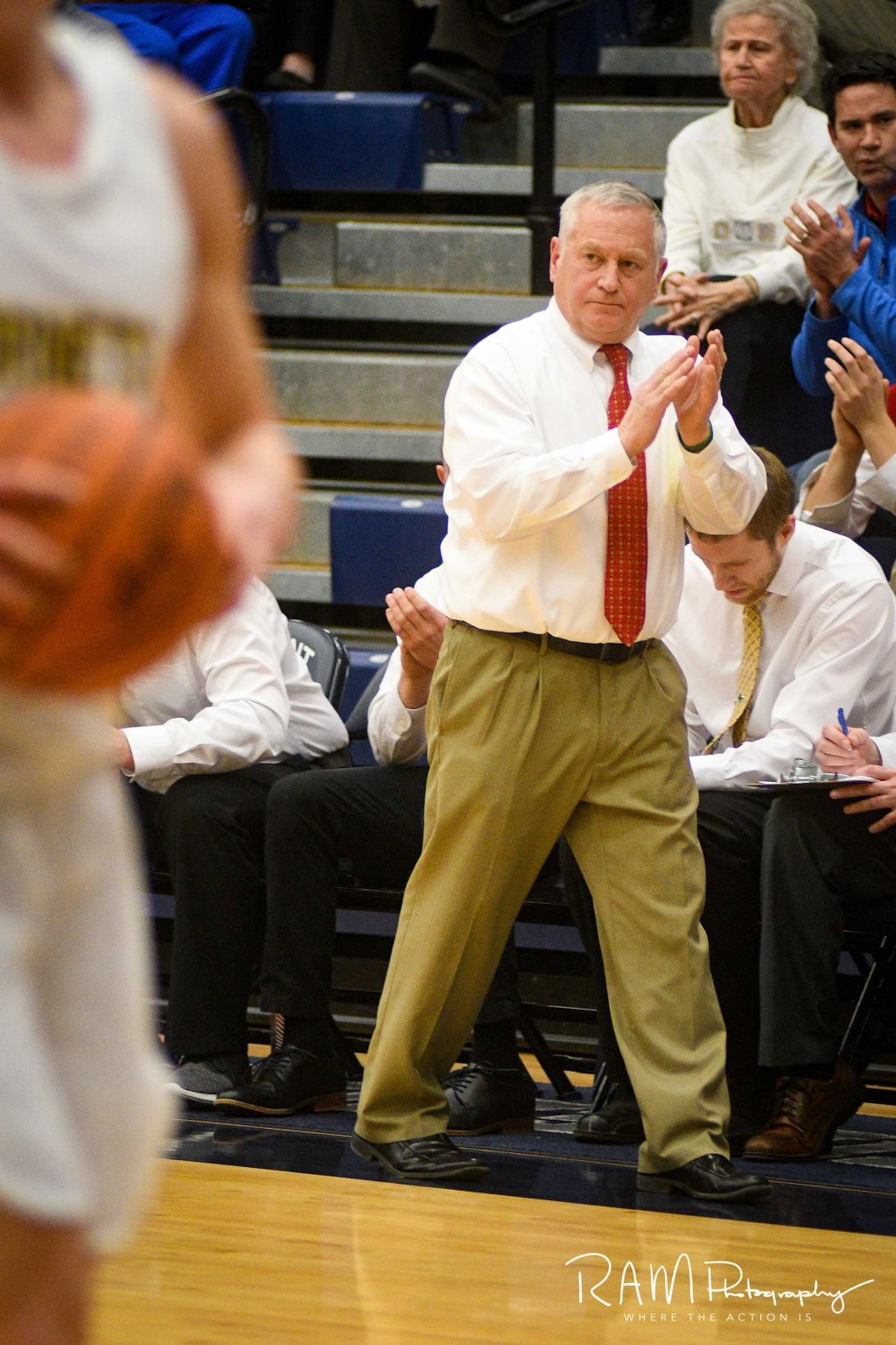 Fenwick coach Pat Kreke claps for his team during Wednesday night’s Division II sectional basketball game against Monroe at Fairmont’s Trent Arena. Fenwick won 60-39. ROB MCCULLEY/RAM PHOTOGRAPHY