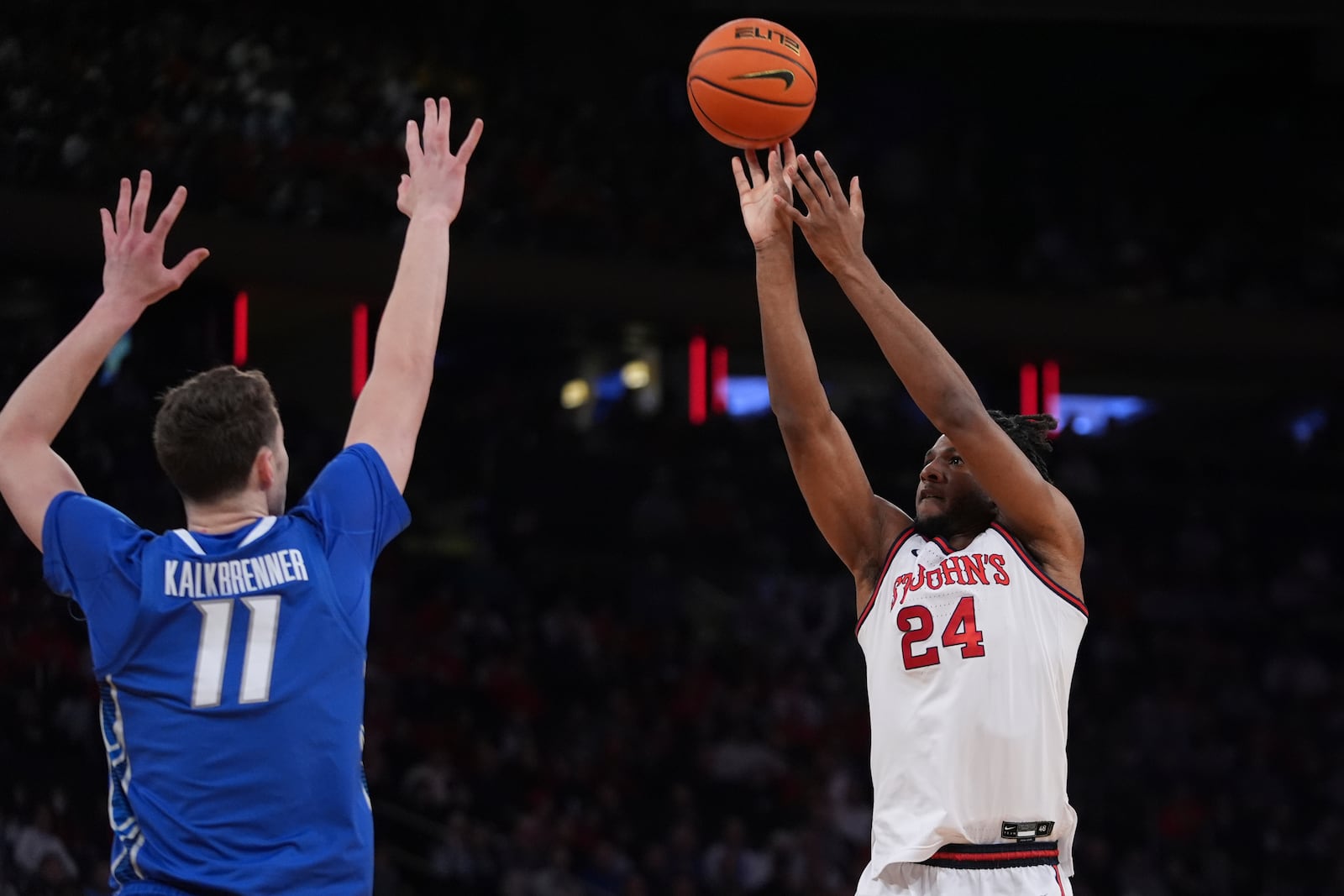 St. John's's Zuby Ejiofor (24) shoots over Creighton's Ryan Kalkbrenner (11) during the first half of an NCAA college basketball game in the championship of the Big East Conference tournament Saturday, March 15, 2025, in New York. (AP Photo/Frank Franklin II)