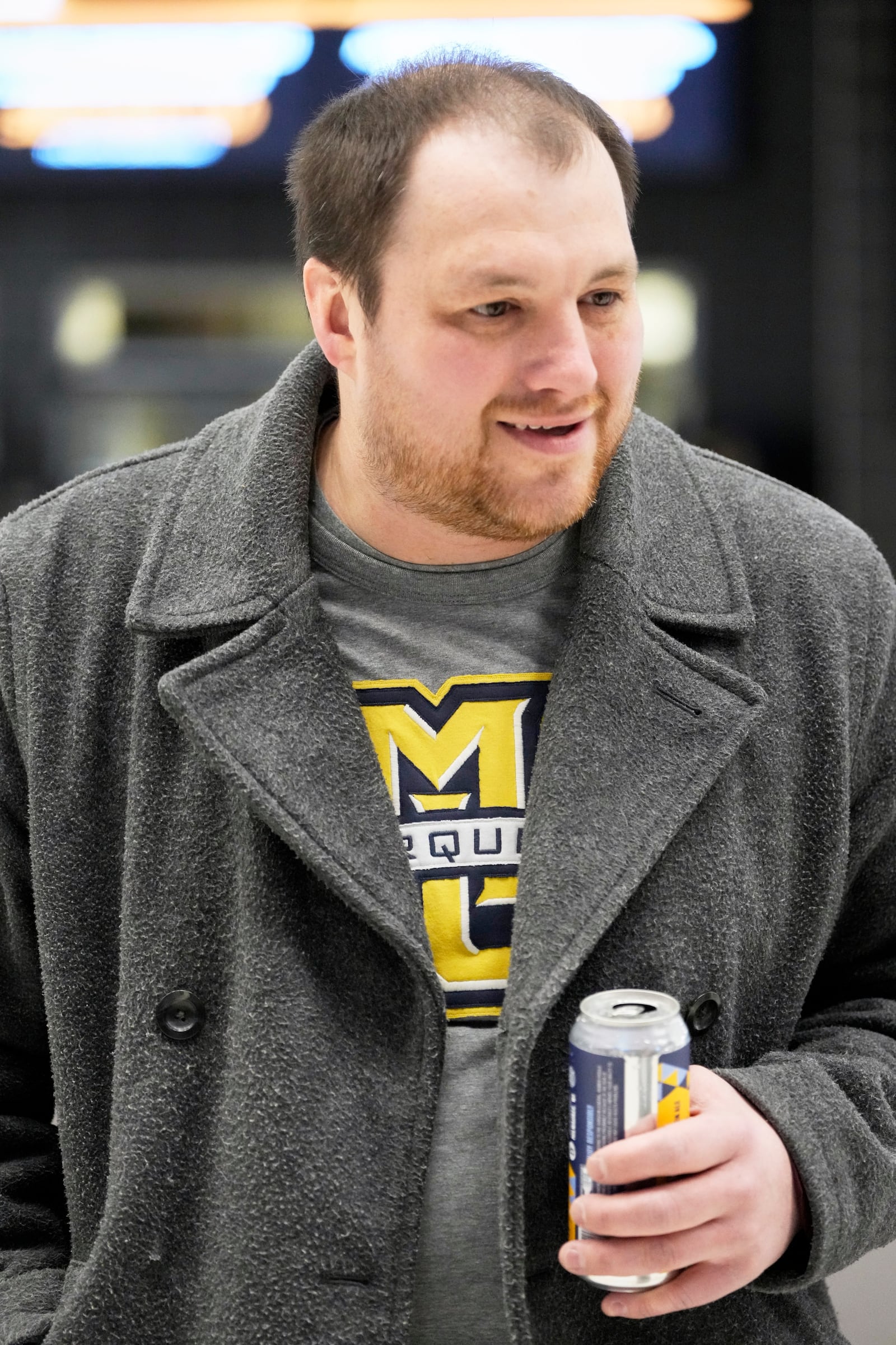 Spencer Peck drinks a Third Space Marquette beer before an NCAA college basketball game Tuesday, Feb. 11, 2025, in Milwaukee. (AP Photo/Morry Gash)