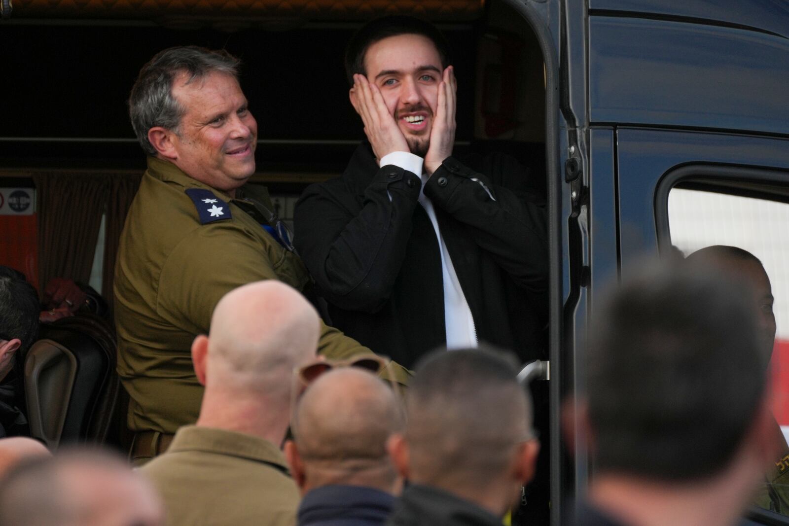 Freed Israeli hostage Omer Shem Tov gestures from a van as he arrives at Beilinson hospital in Petah Tikva, Israel, after he was released from Hamas captivity in the Gaza Strip, Saturday, Feb. 22, 2025. (AP Photo/Ohad Zwigenberg)