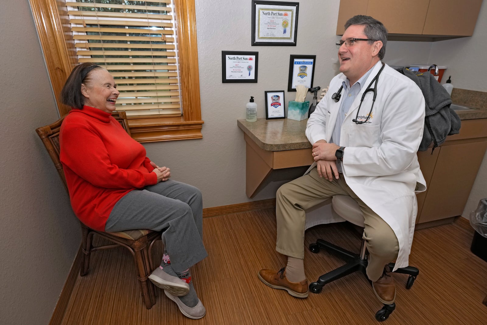 Dr. Lee Gross, right, talks with patient Annie Geisel at the Epiphany Health Direct Primary Care Tuesday, Jan. 21, 2025, in Port Charlotte, Fla. (AP Photo/Chris O'Meara)