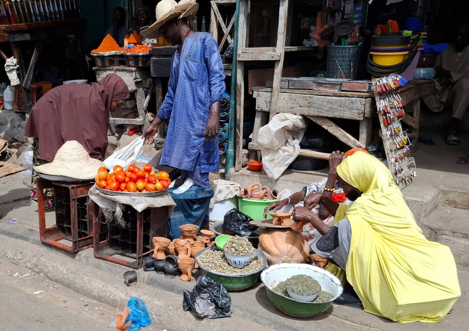 A man sells tomatoes at the main market in Maiduguri, Nigeria, Saturday, March 15, 2025. (AP Photo/Joshua Olatunji)