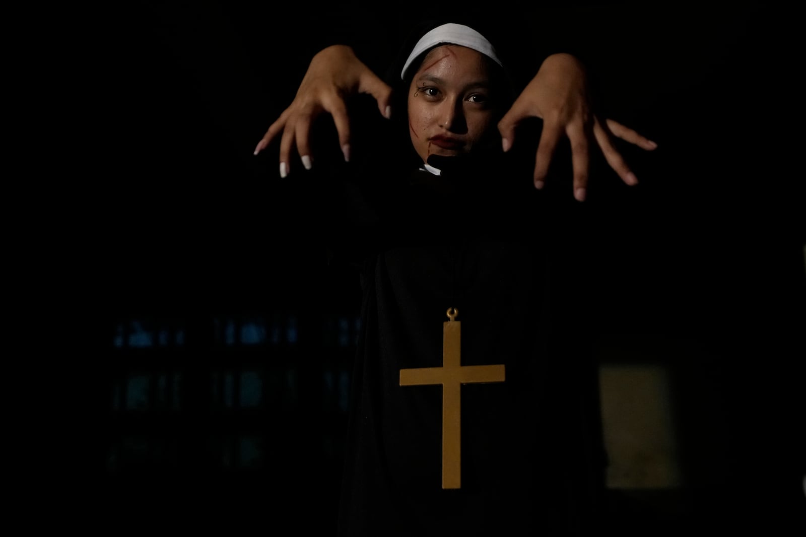 A visitor dressed in a ghost costume at Goosebump market as a part of Halloween festival in Bangkok, Thailand, Wednesday, Oct. 30, 2024. (AP Photo/Sakchai Lalit)