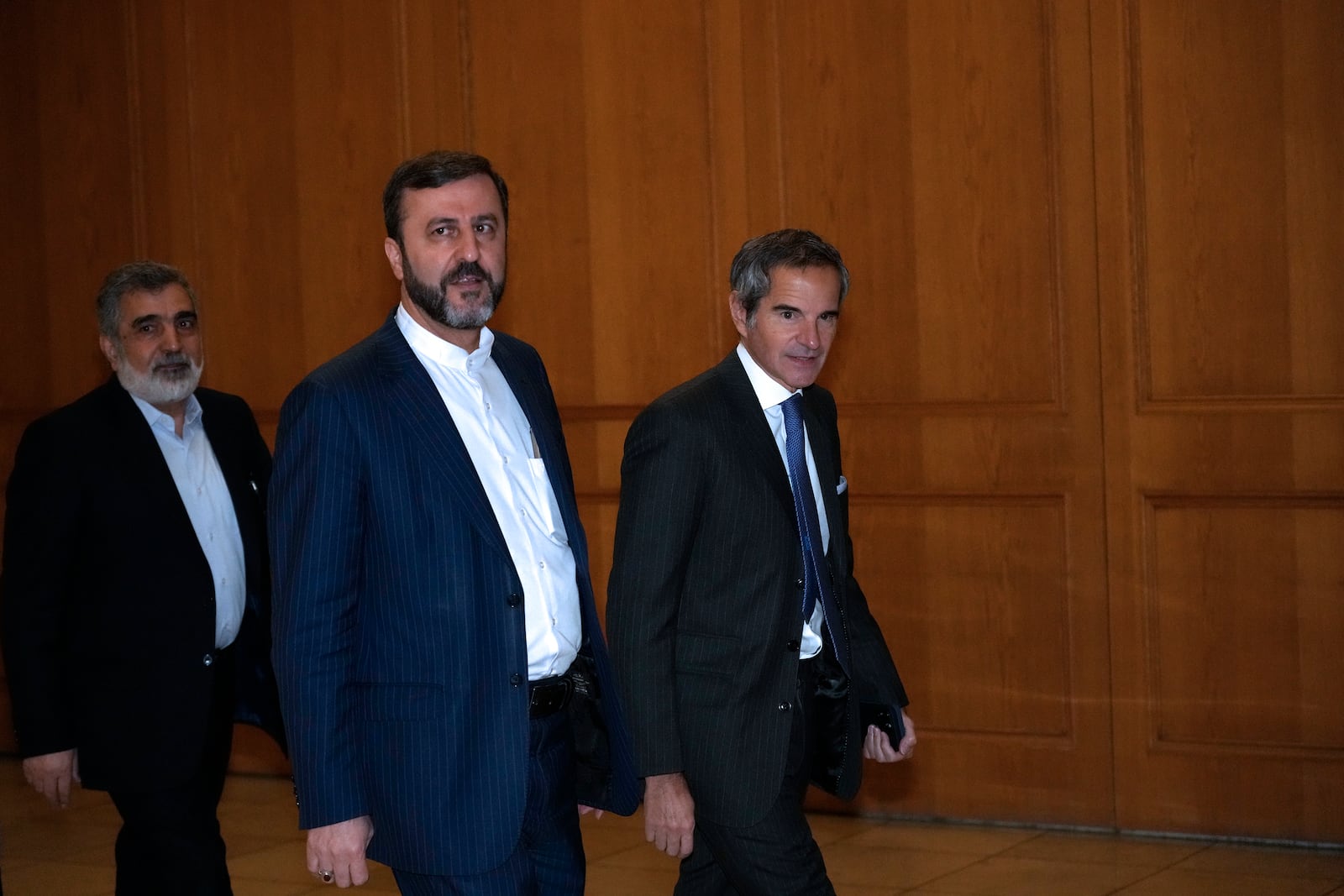 International Atomic Energy Agency (IAEA) Director General Rafael Mariano Grossi, right, arrives for a meeting with Iranian Foreign Minister Abbas Araghchi, unseen, as he is accompanied by Deputy Foreign Minister Kazem Gharib Abadi, second right, and Deputy Chief of Atomic Energy Organization of Iran, Behrouz Kamalvandi in Tehran, Iran, Thursday, Nov. 14, 2024. (AP Photo/Vahid Salemi)