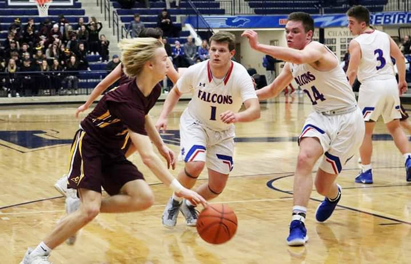 Dylan Zimmerman of Ross drives on Clinton-Massie’s Daulton Wolfe (1) and Griffin Laake (24) during Friday night’s Division II sectional basketball game at Fairmont’s Trent Arena in Kettering. Clinton-Massie won 61-54 in overtime. CONTRIBUTED PHOTO BY TERRI ADAMS