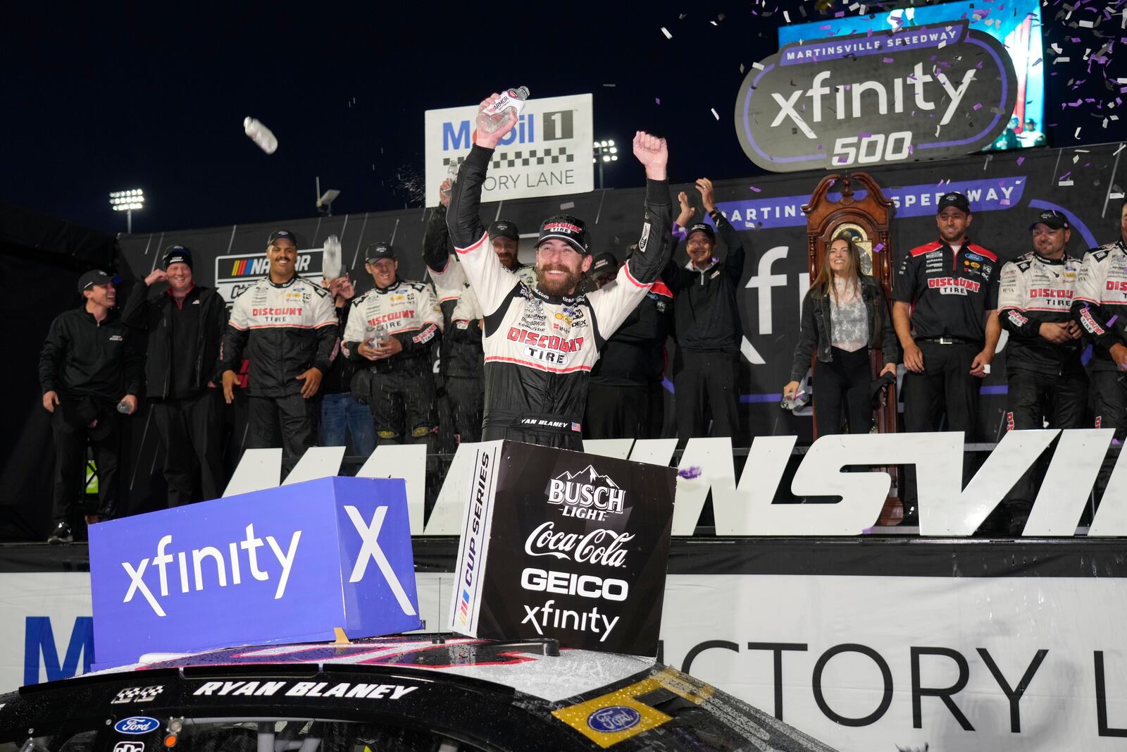 Ryan Blaney, center, celebrates in Victory Lane after winning a NASCAR Cup Series auto race at Martinsville Speedway in Martinsville, Va., Sunday, Nov. 3, 2024. (AP Photo/Chuck Burton)