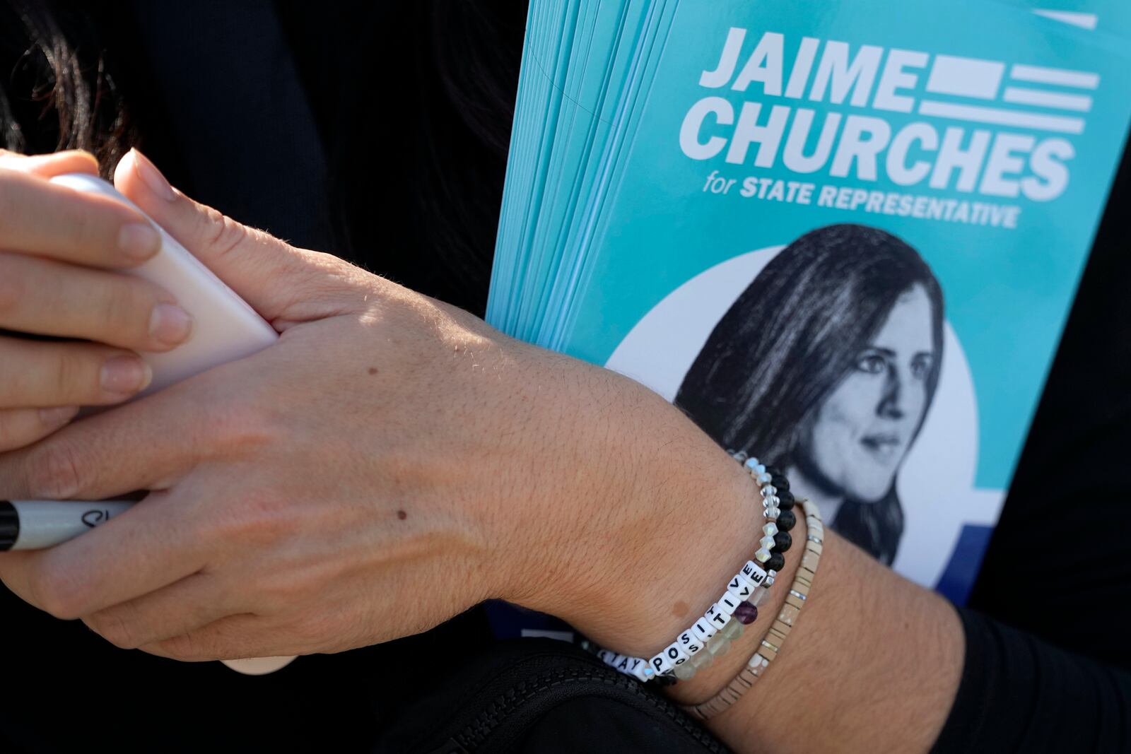 Democratic state Rep. Jaime Churches goes door to door campaigning as she seeks a second term in the state House, Friday, Oct. 11, 2024, in Trenton, Mich. (AP Photo/Carlos Osorio)