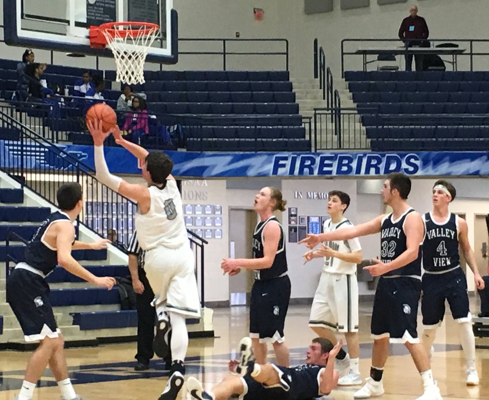 Badin’s Jakob Tipton (0) goes to the basket as Valley View’s Sam Whisman (24) goes to the floor during Saturday afternoon’s Division II sectional game at Fairmont’s Trent Arena. RICK CASSANO/STAFF