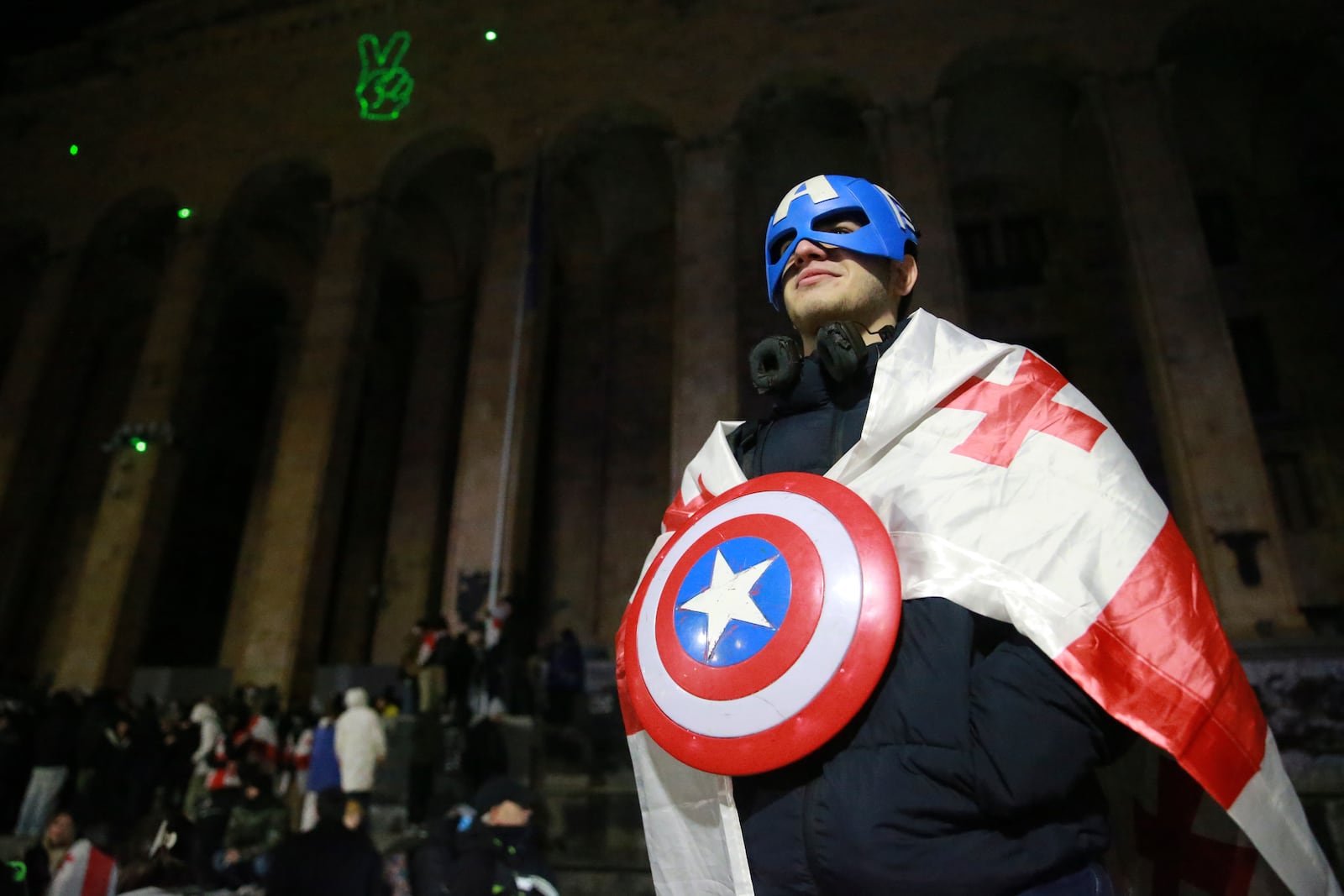 A demonstrator attends a rally outside the parliament's building to protests against the government's decision to suspend negotiations on joining the European Union in Tbilisi, Georgia, on Tuesday, Dec. 3, 2024. (AP Photo/Zurab Tsertsvadze)