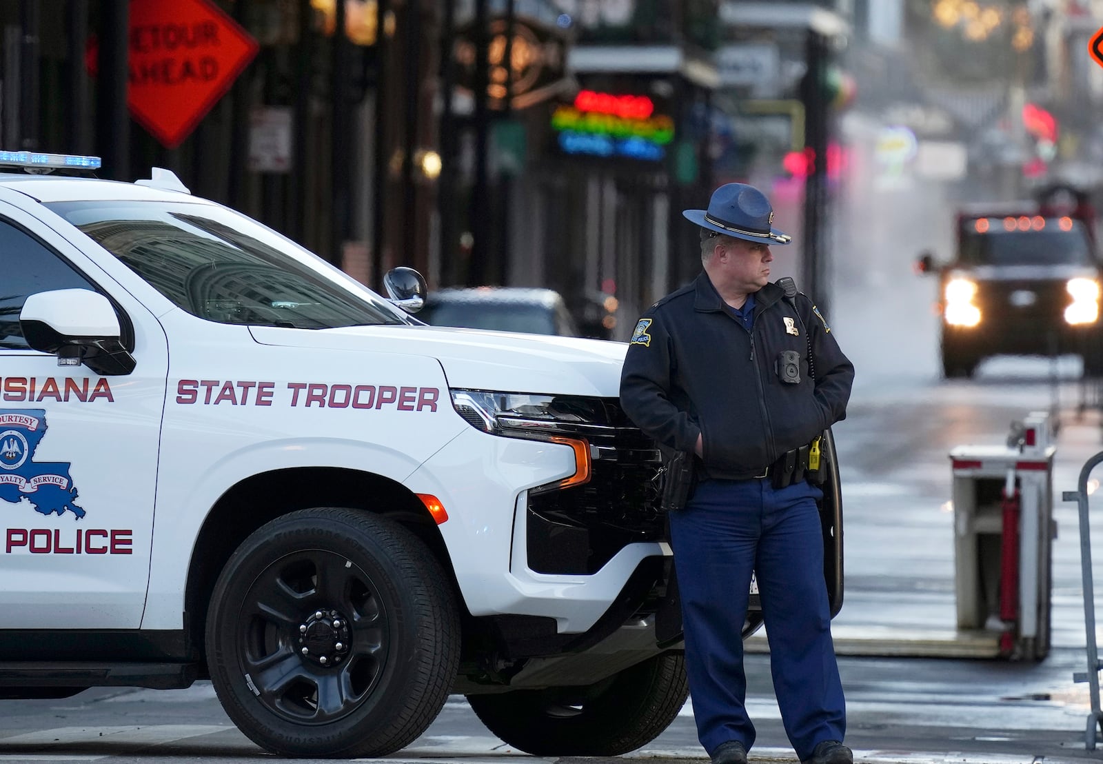 A state trooper stands by New Orleans' Canal and Bourbon streets, Thursday, Jan. 2, 2025. (AP Photo/George Walker IV)