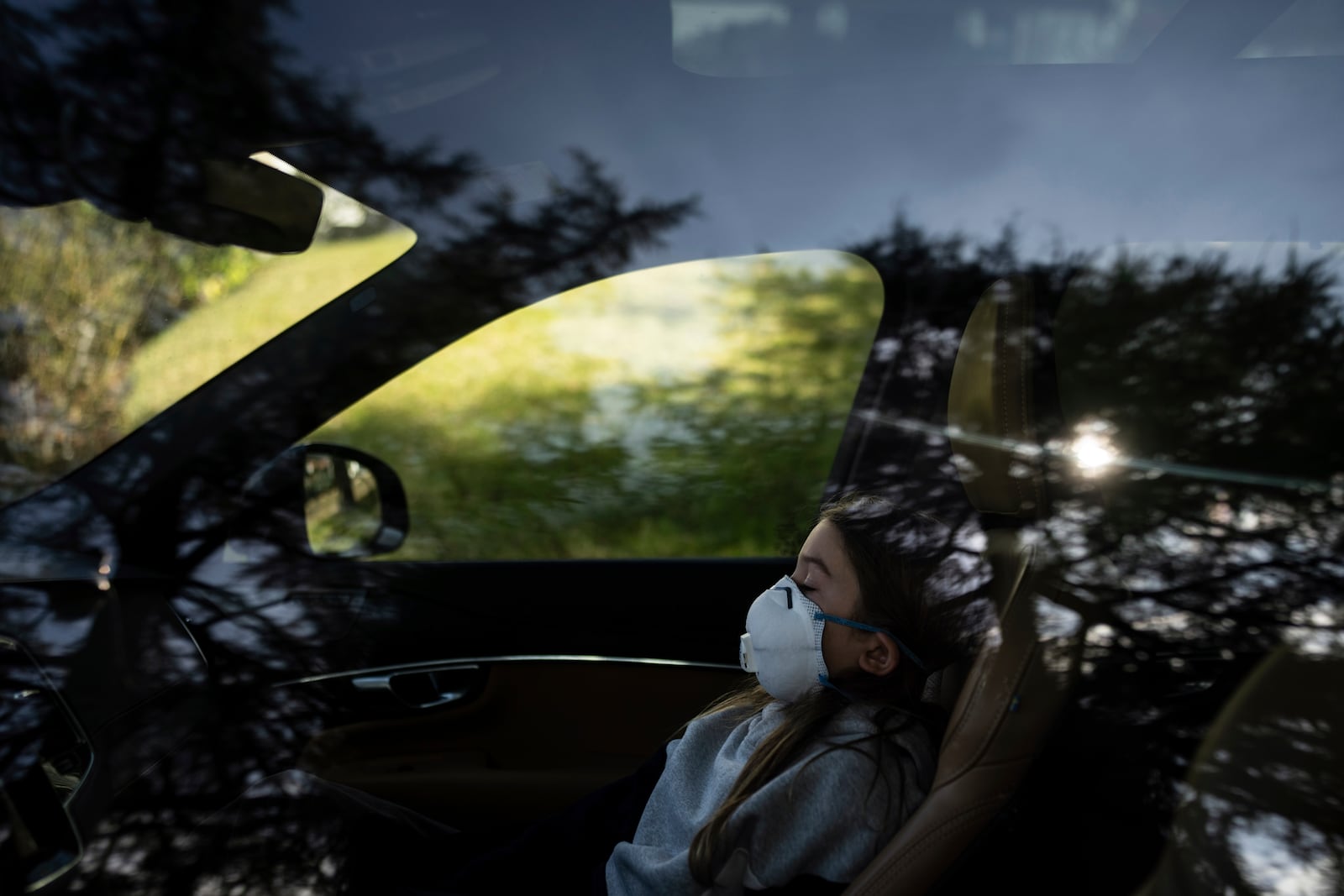 Ceiba Phillips, an 11-year-old Eaton Fire evacuee, sits in his family's car after visiting his home for the first time since the fire in Altadena, Calif., Saturday, Feb. 8, 2025. (AP Photo/Jae C. Hong)